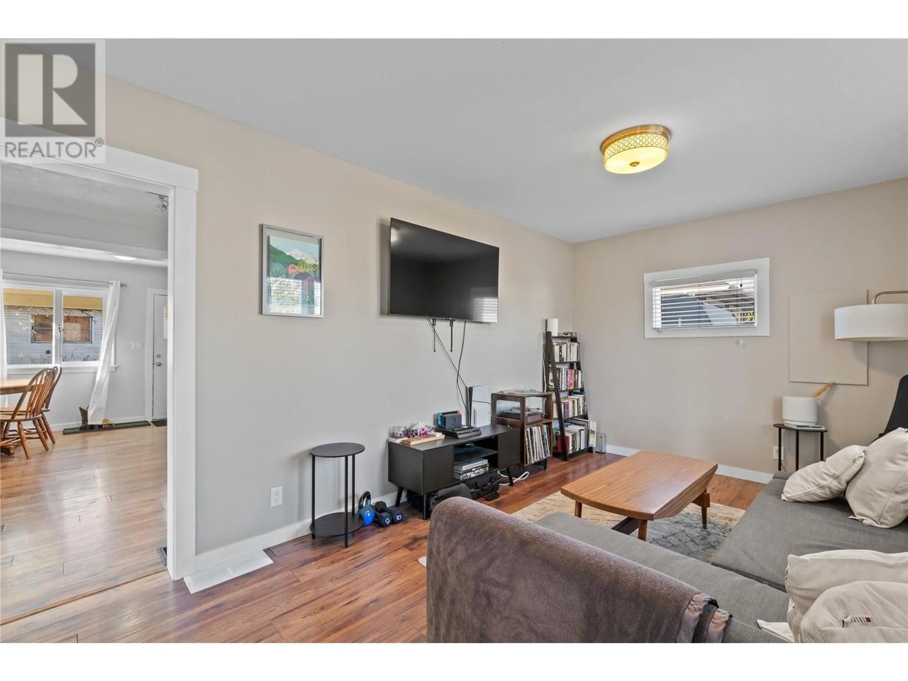 Living room with furniture, wood/laminate floor for 2300 38 AVENUE, Vernon British Columbia V1T2Z4