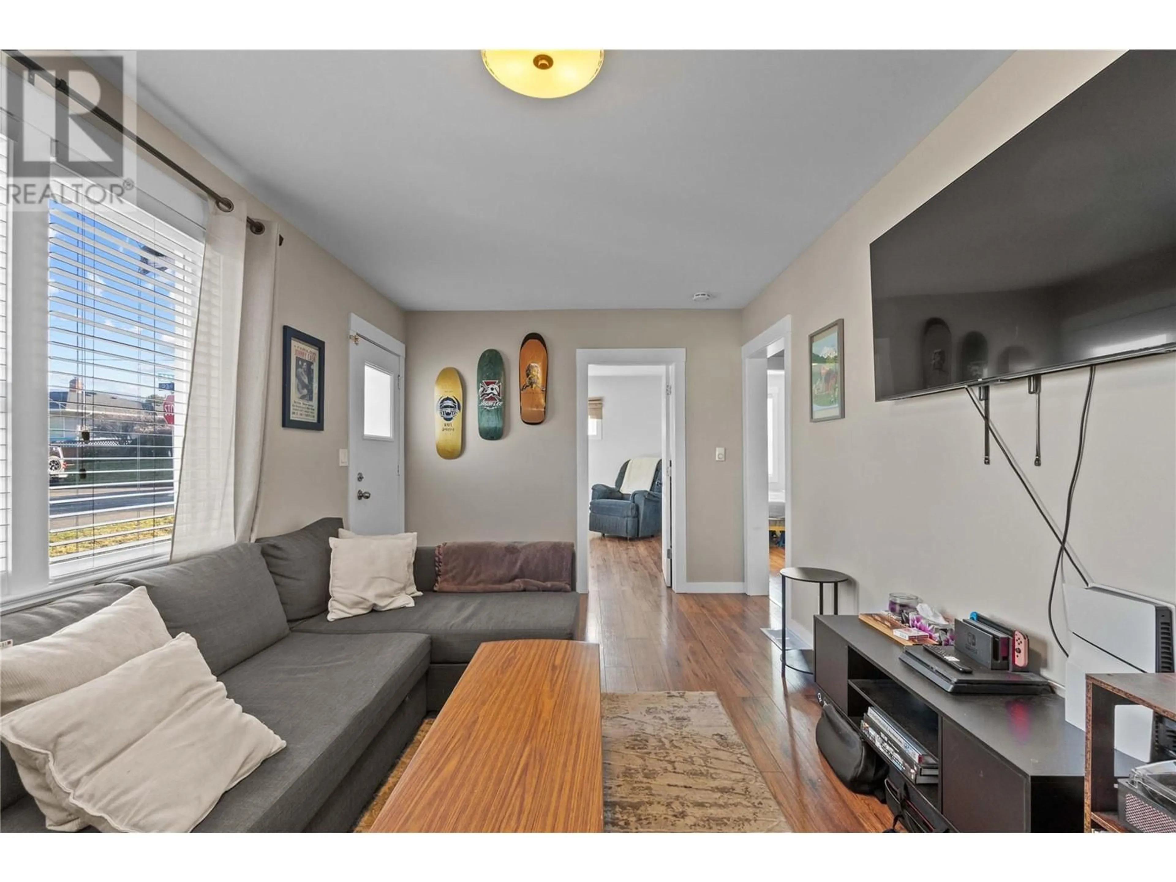 Living room with furniture, wood/laminate floor for 2300 38 AVENUE, Vernon British Columbia V1T2Z4