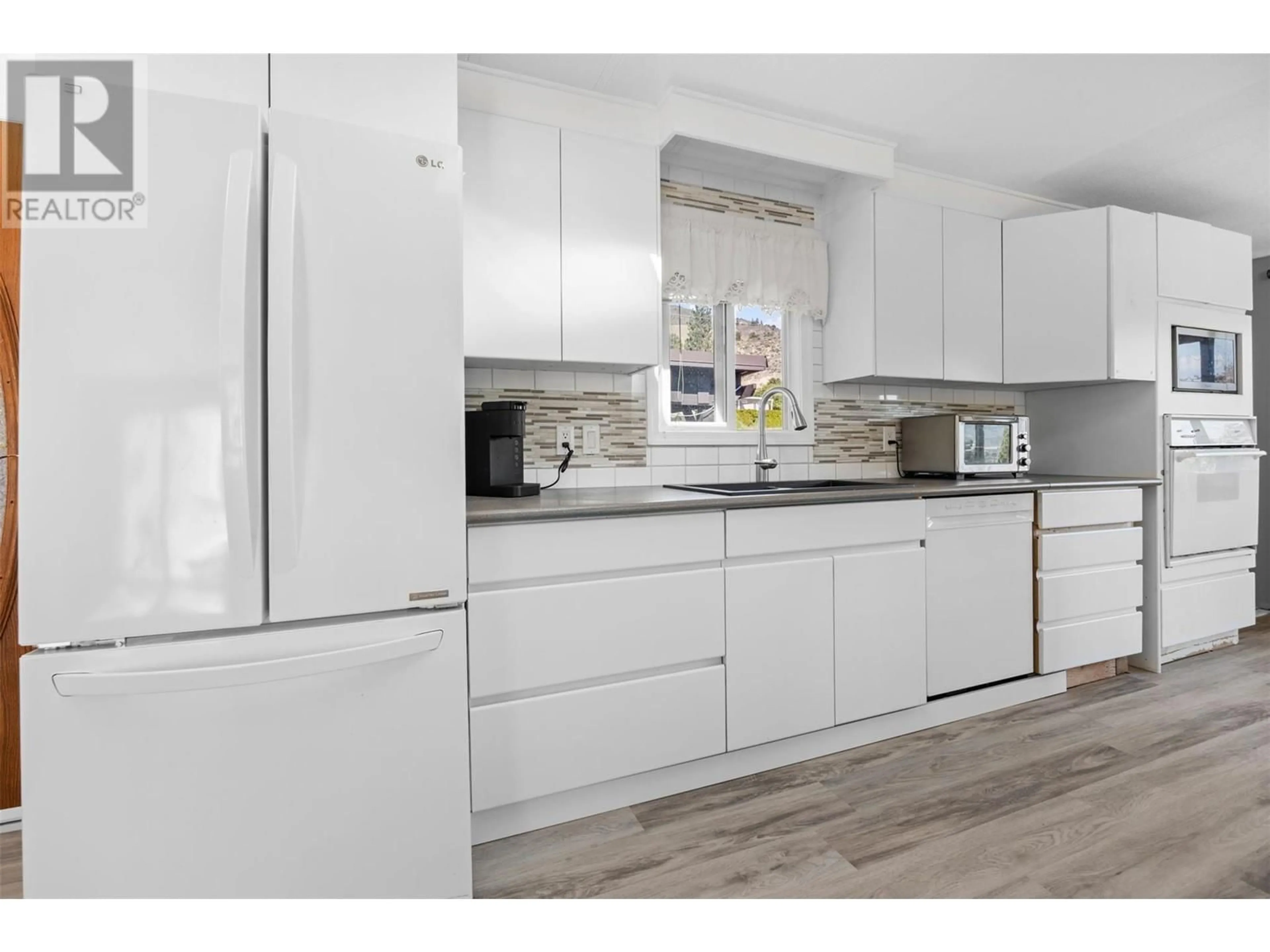 Open concept kitchen, wood/laminate floor for 24 - 201 HIGHWAY 97 HIGHWAY, Penticton British Columbia V2A0E4