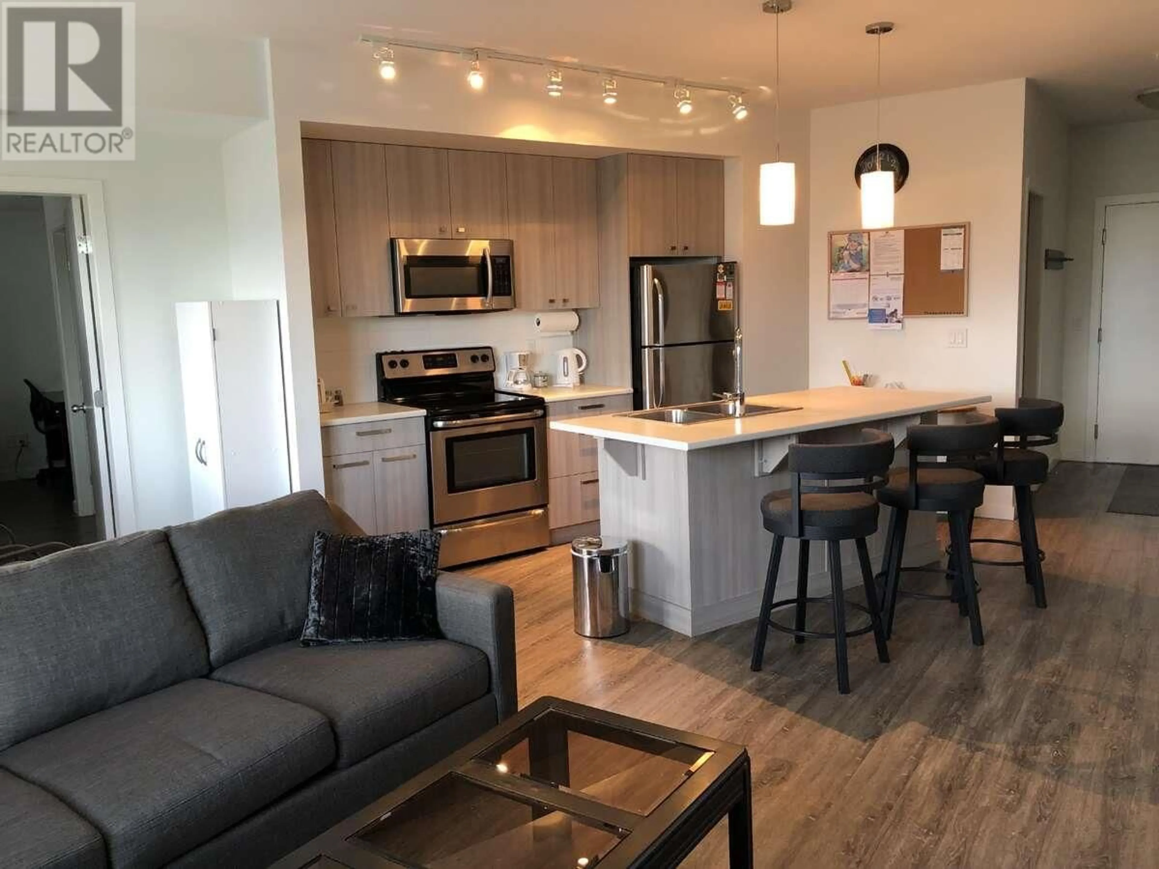 Open concept kitchen, wood/laminate floor for 207 - 935 ACADEMY WAY, Kelowna British Columbia V1V3C9