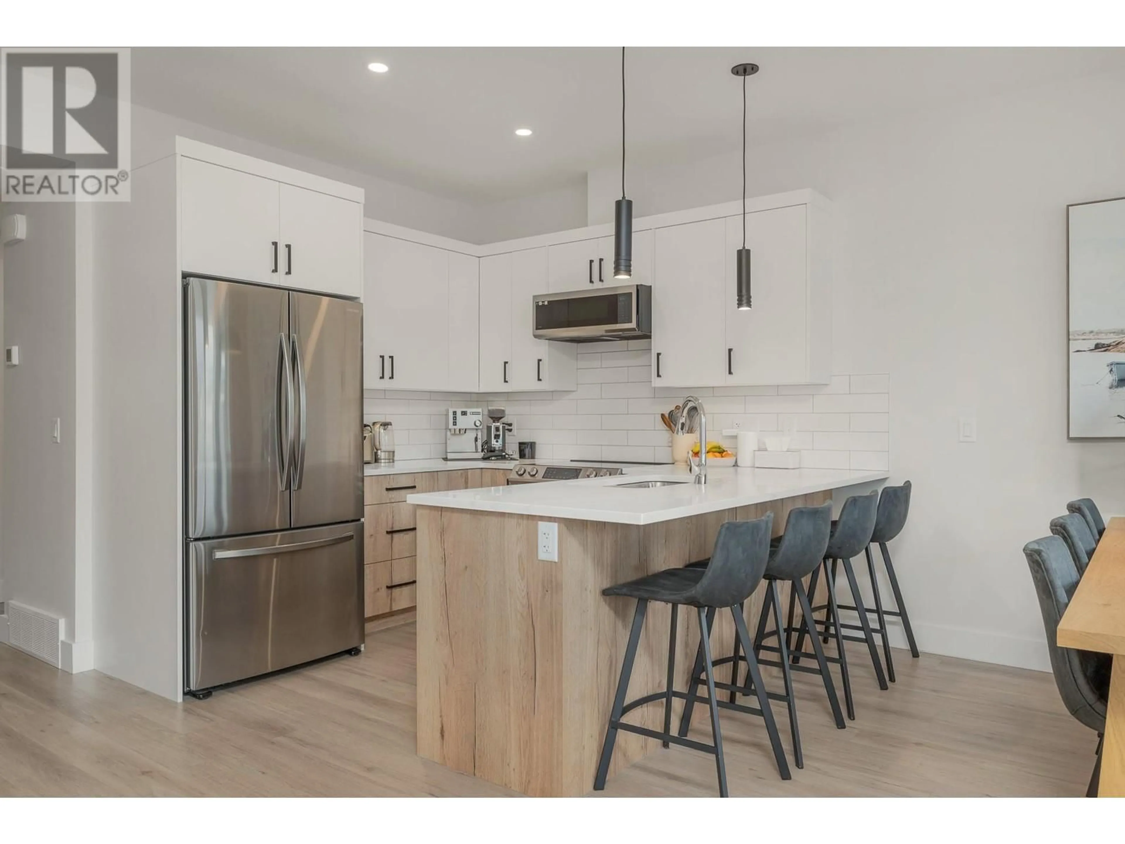 Open concept kitchen, wood/laminate floor for 43 - 1999 15 AVENUE, Vernon British Columbia V1T0C6