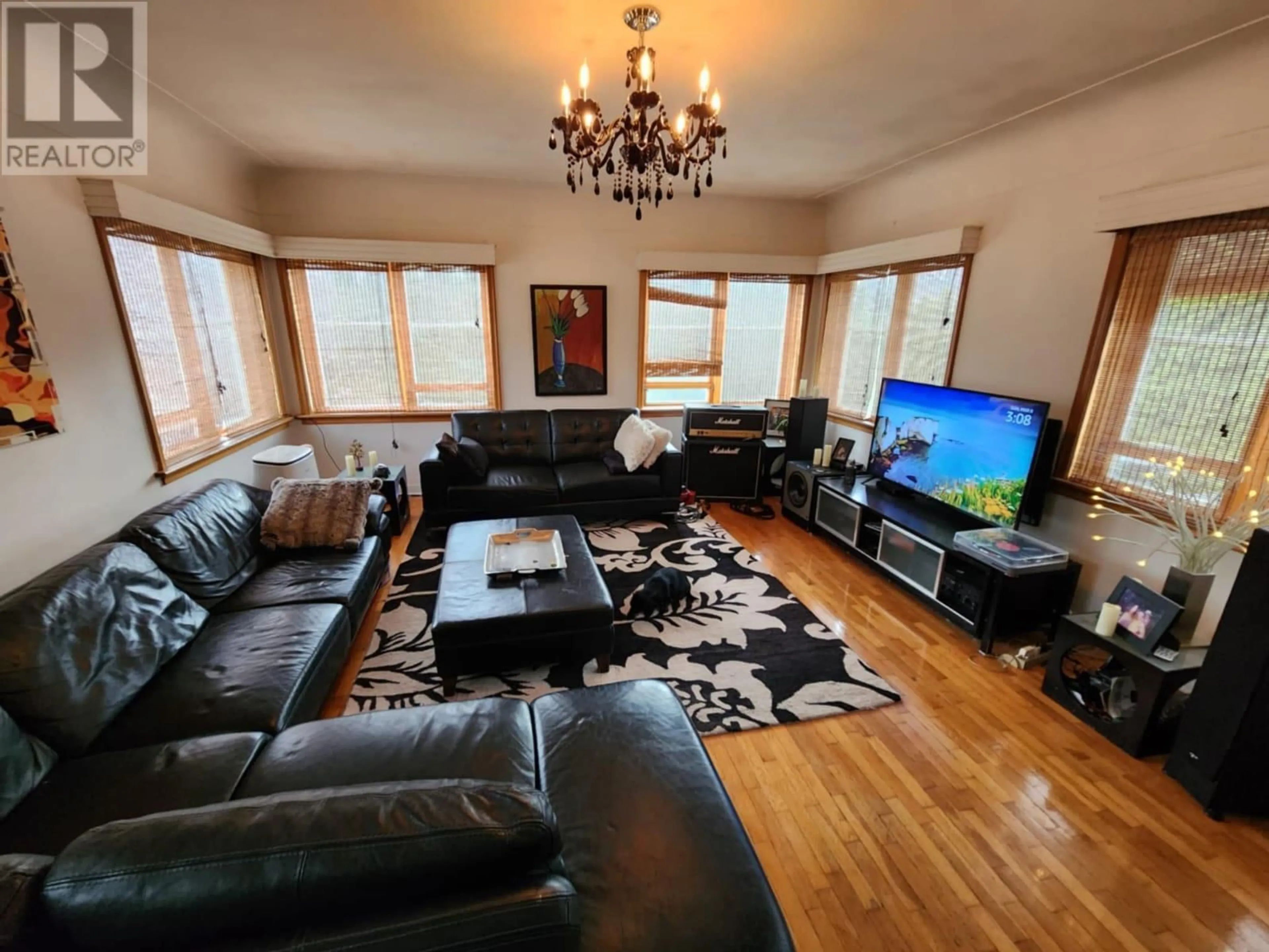 Living room with furniture, wood/laminate floor for 3300 DAHLIA CRESCENT, Trail British Columbia V1R2X9