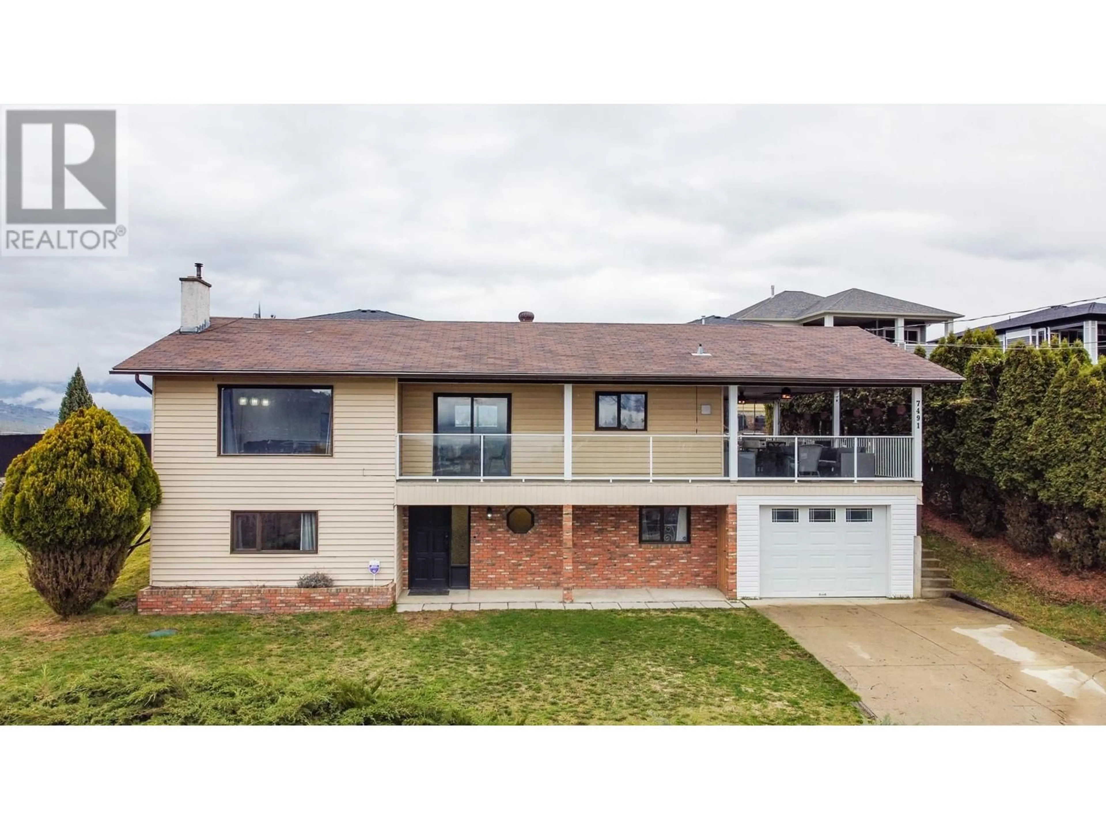 Home with brick exterior material, street for 7491 LONGACRE DRIVE, Vernon British Columbia V1H1G7
