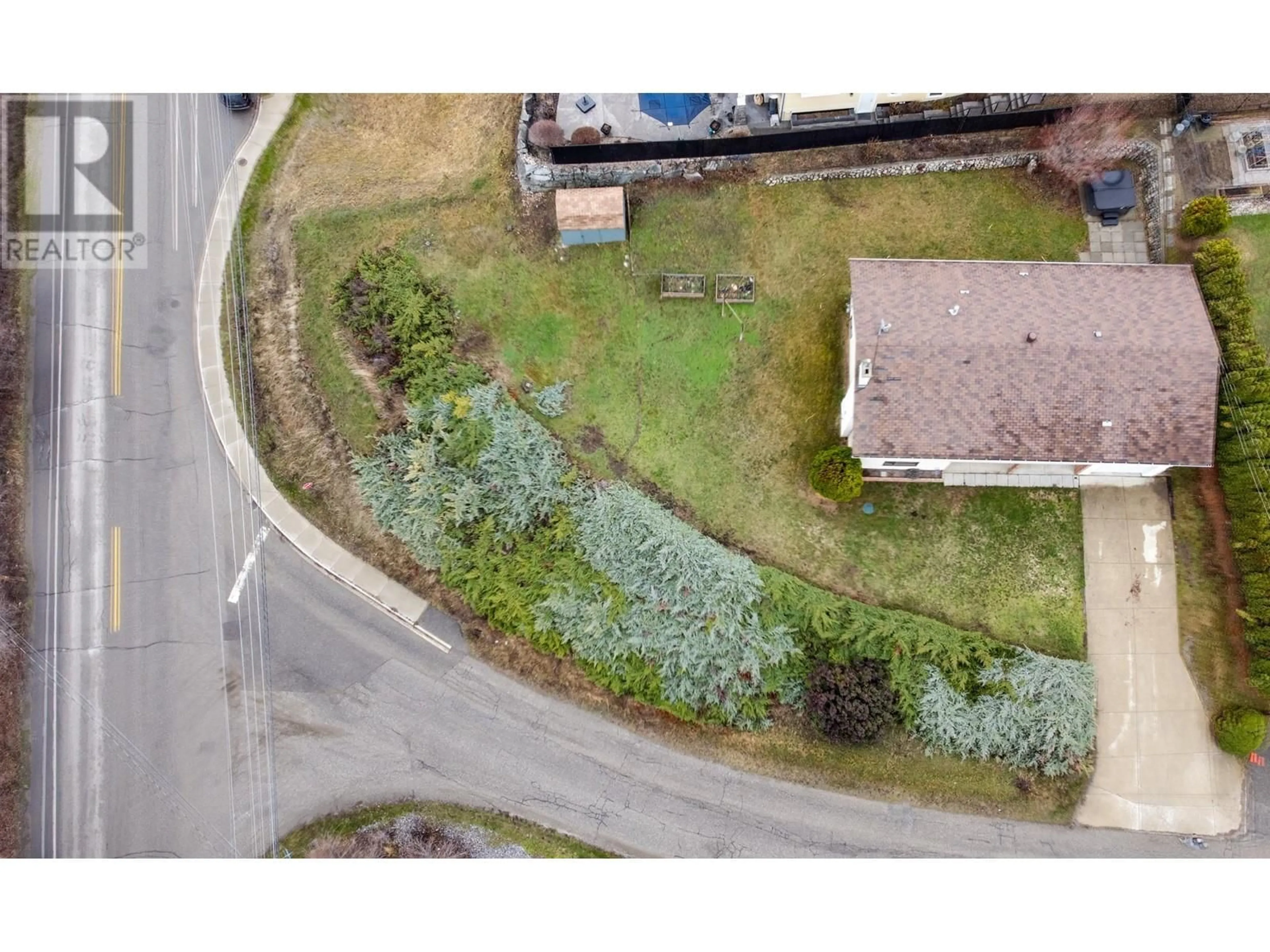 A pic from outside/outdoor area/front of a property/back of a property/a pic from drone, street for 7491 LONGACRE DRIVE, Vernon British Columbia V1H1G7
