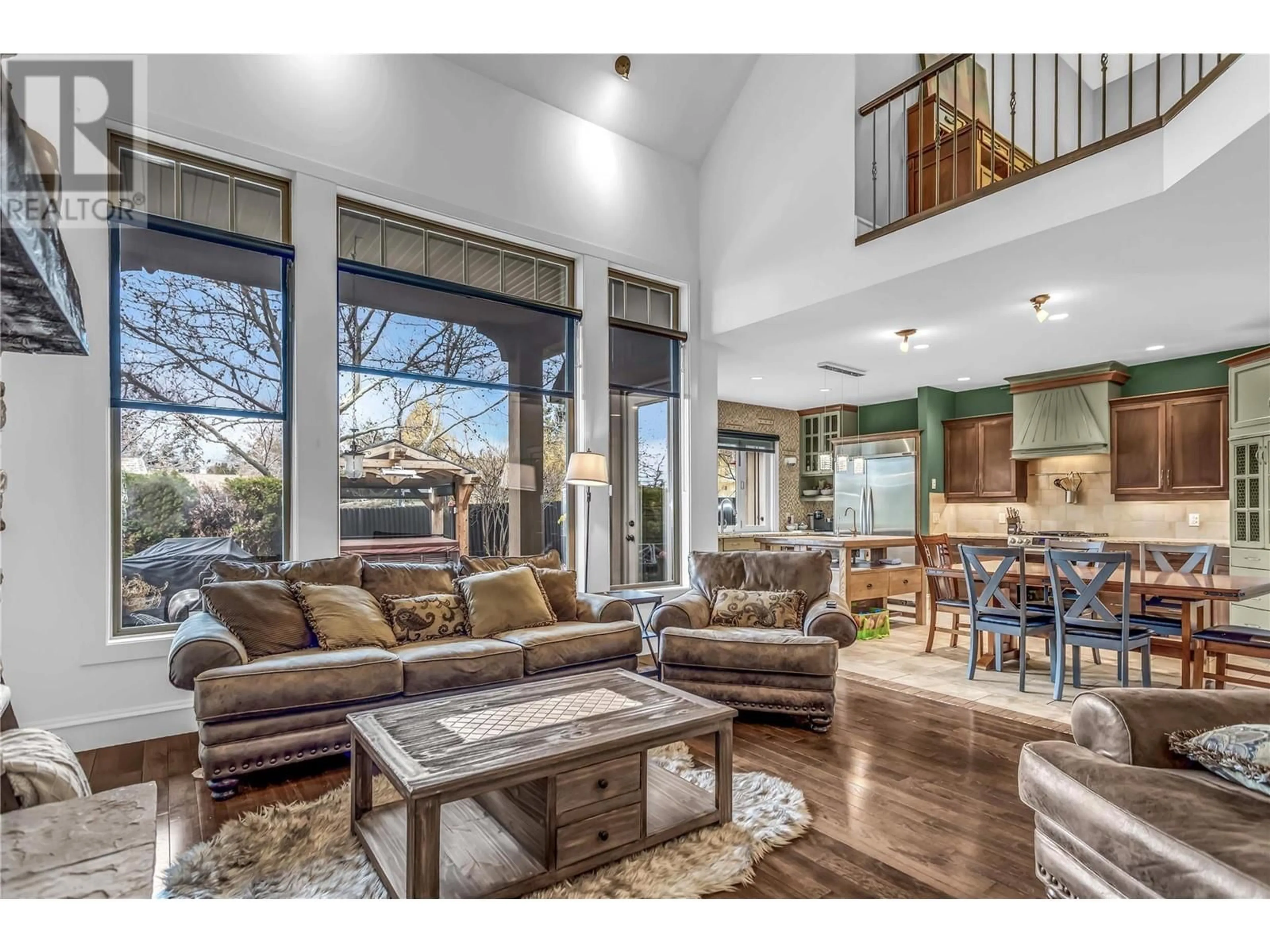 Living room with furniture, wood/laminate floor for 1306 BLACK MOUNTAIN CRESCENT, Kelowna British Columbia V1P1P7