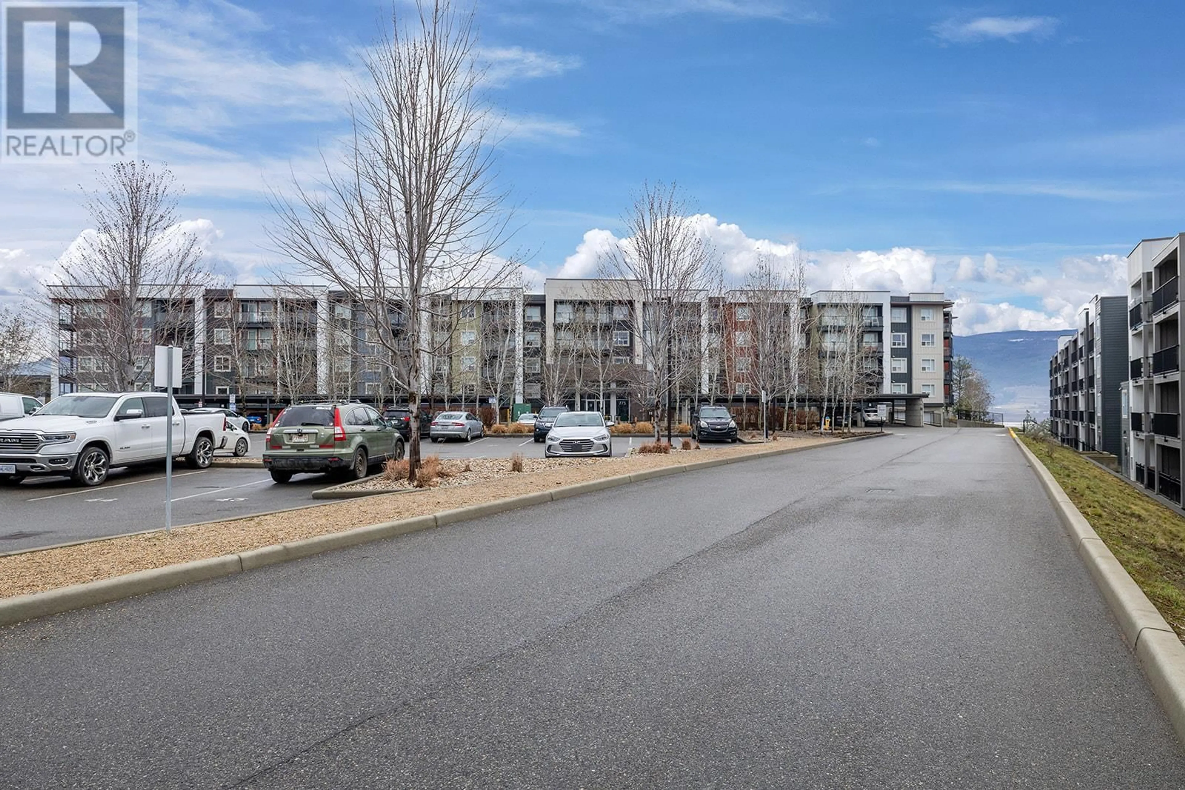 A pic from outside/outdoor area/front of a property/back of a property/a pic from drone, street for 312 - 775 ACADEMY WAY, Kelowna British Columbia V1V0A5