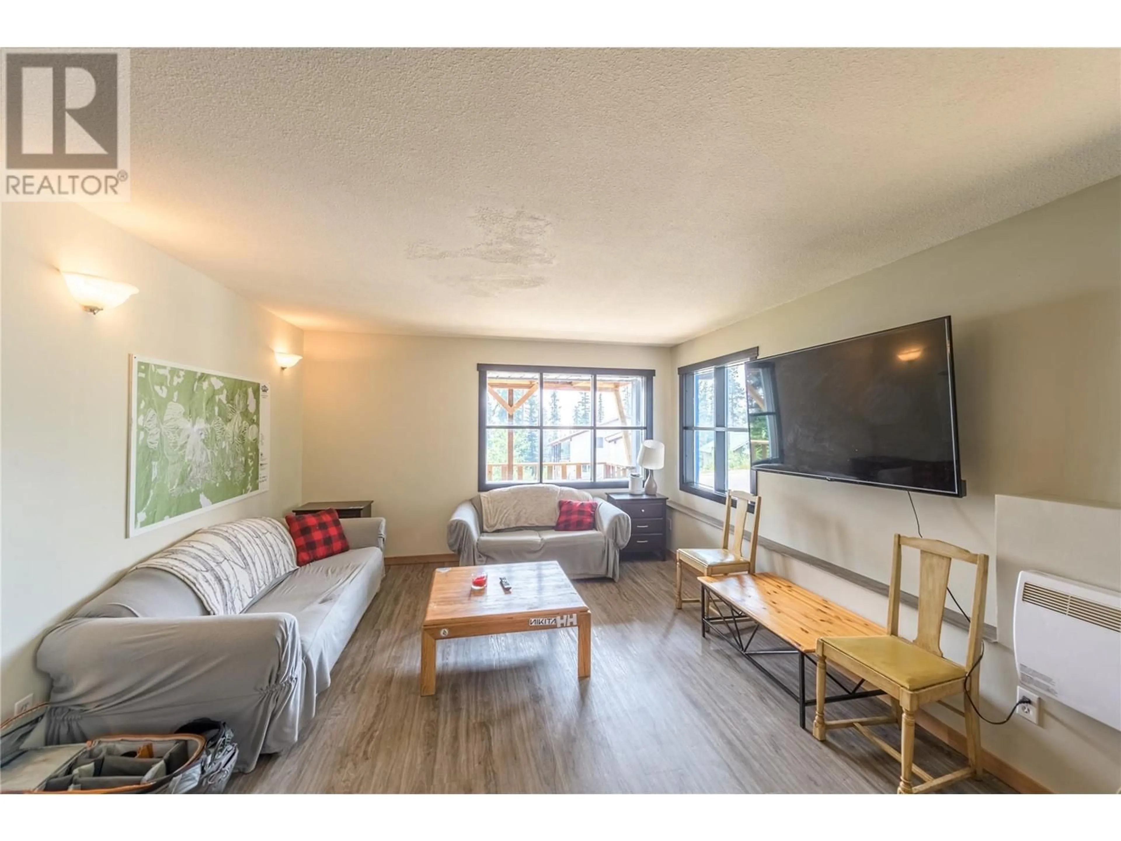 Living room with furniture, wood/laminate floor for 1 - 4906 SNOW PINES ROAD, Big White British Columbia V1P1P3