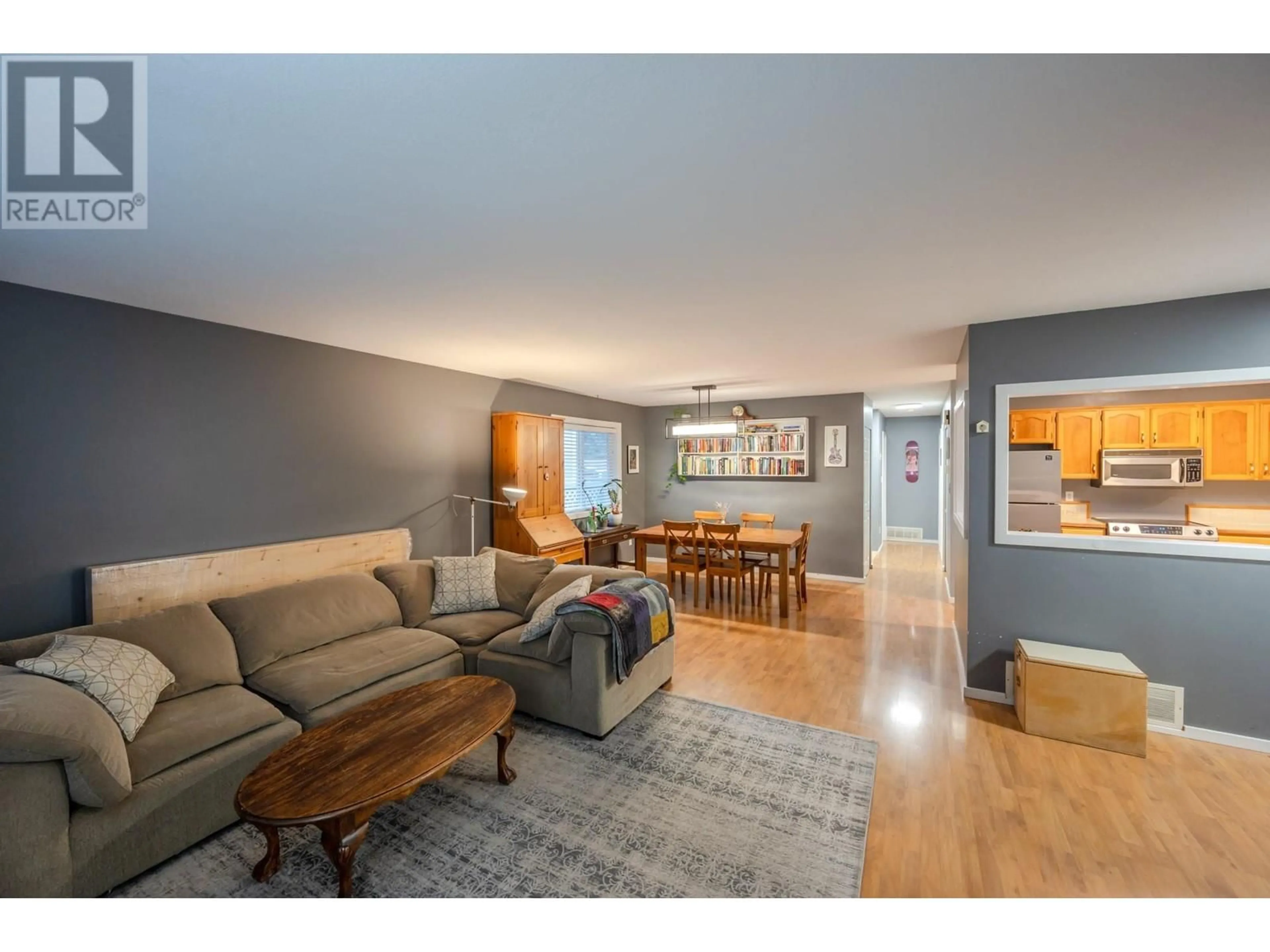 Living room with furniture, wood/laminate floor for 181 WADE AVENUE WEST, Penticton British Columbia V2A1T7