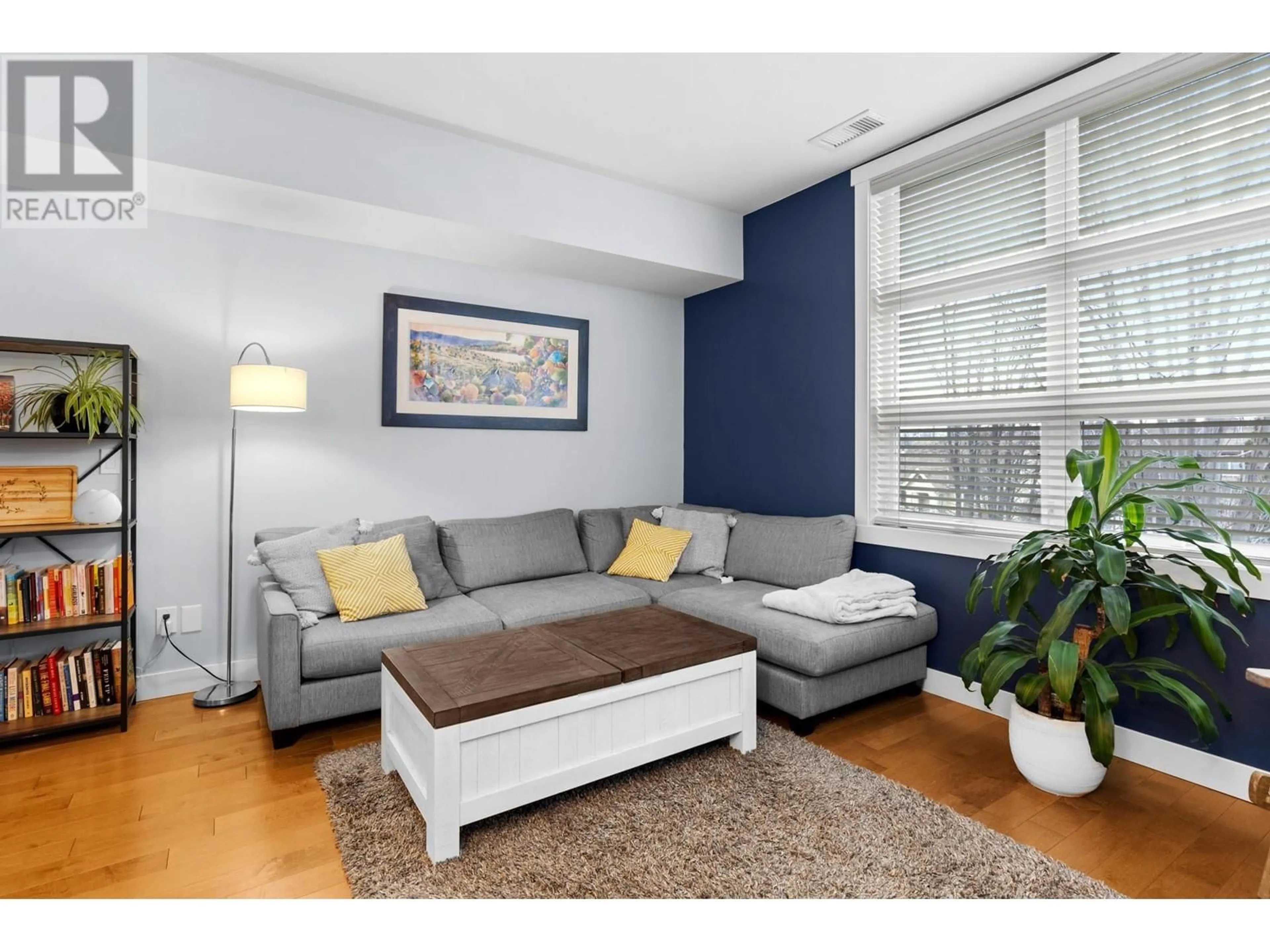 Living room with furniture, wood/laminate floor for 214 - 700 MARTIN AVENUE, Kelowna British Columbia V1Y6V4