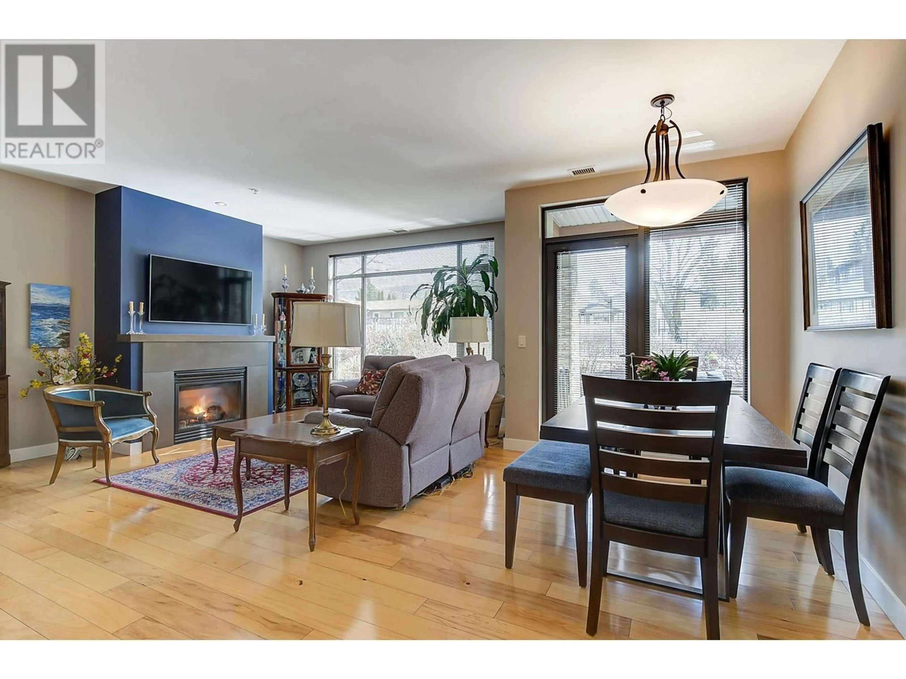 Living room with furniture, wood/laminate floor for 109 - 600 SARSONS ROAD, Kelowna British Columbia V1W5H5