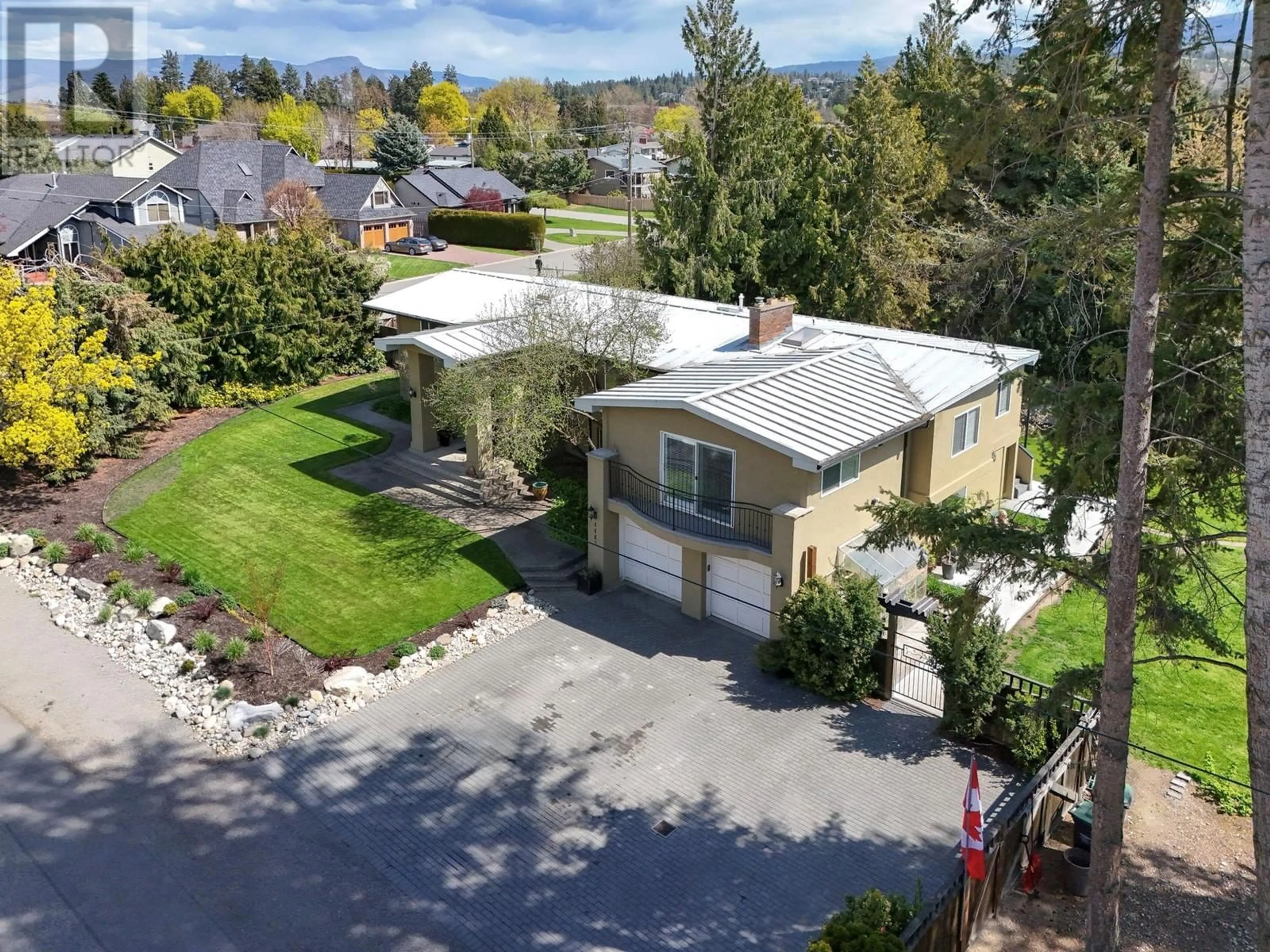A pic from outside/outdoor area/front of a property/back of a property/a pic from drone, street for 4467 LAKELAND ROAD, Kelowna British Columbia V1W1E1