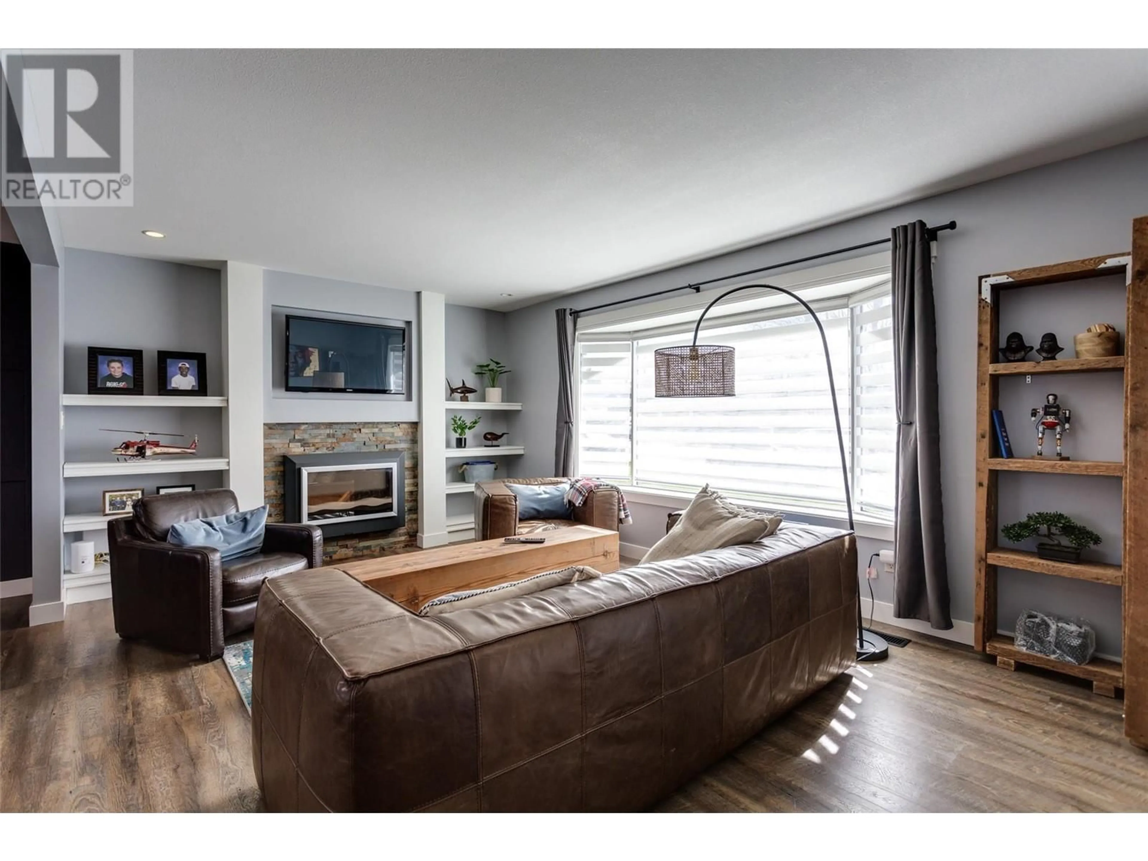 Living room with furniture, wood/laminate floor for 1209 36 AVENUE, Vernon British Columbia V1T2V2