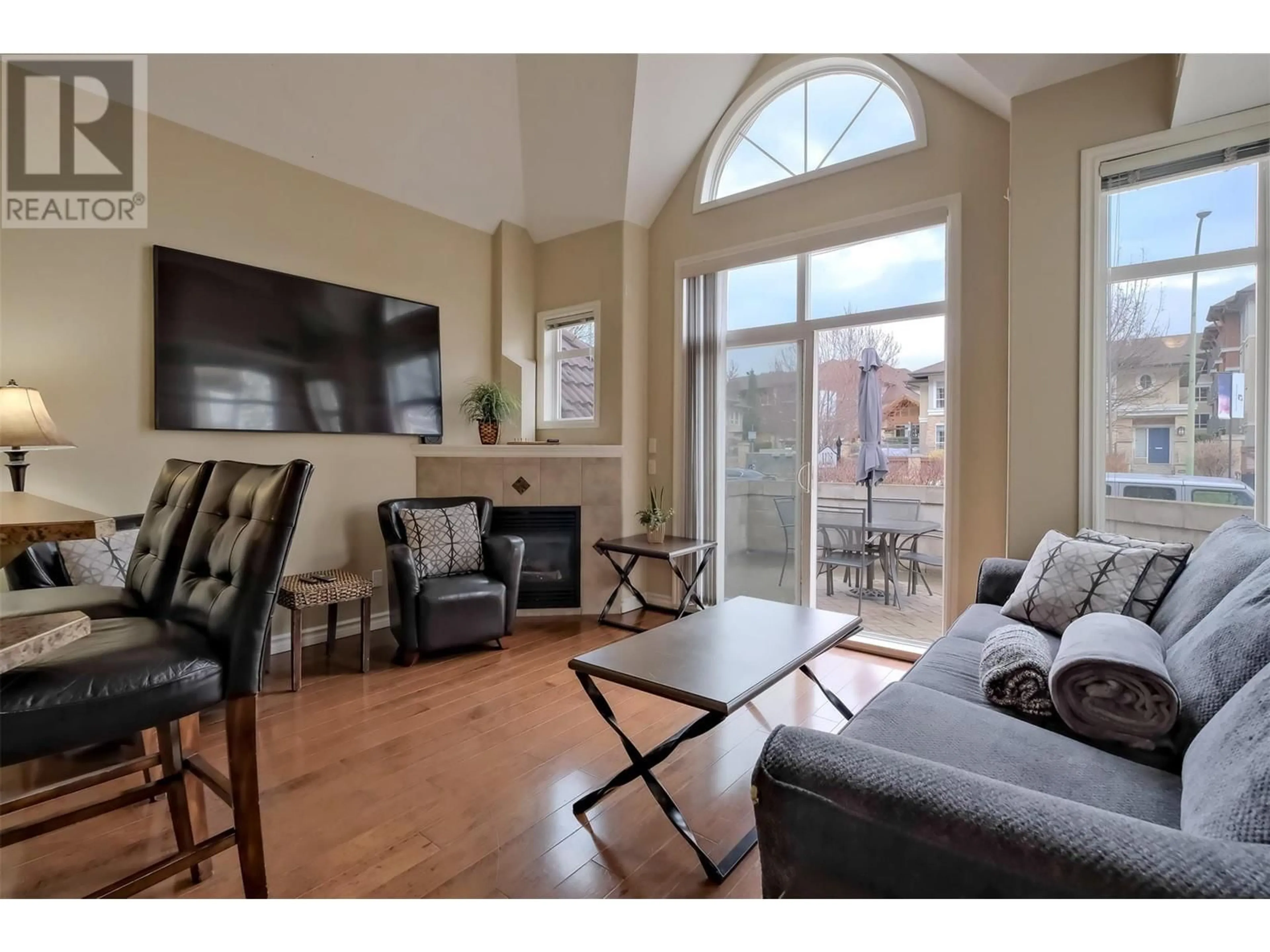 Living room with furniture, wood/laminate floor for 101 - 1128 SUNSET DRIVE, Kelowna British Columbia V1Y9W7