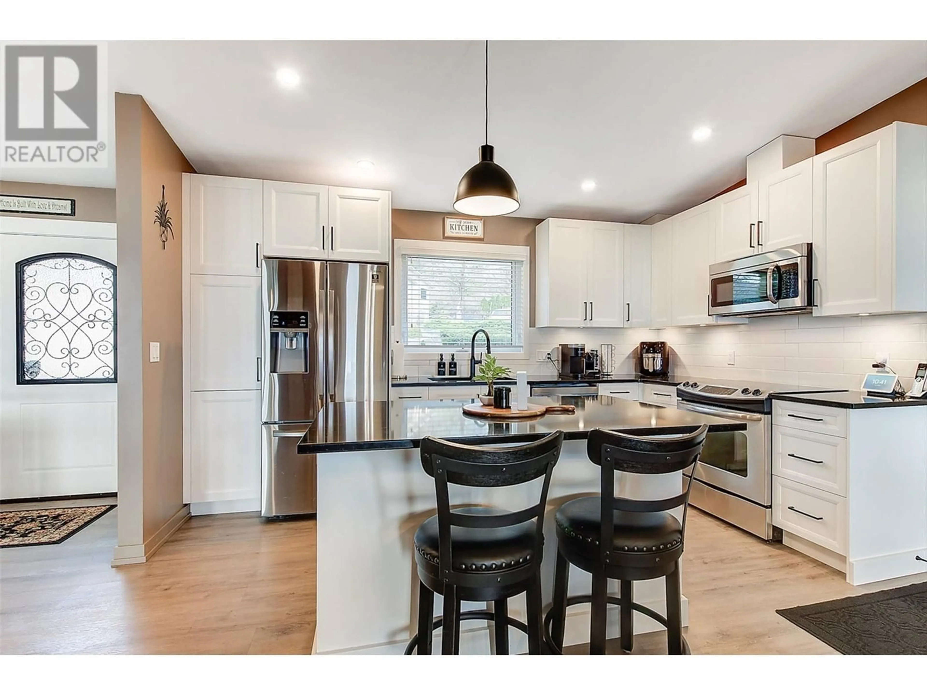 Open concept kitchen, wood/laminate floor for 4147 PONDEROSA DRIVE, Peachland British Columbia V0H1X5