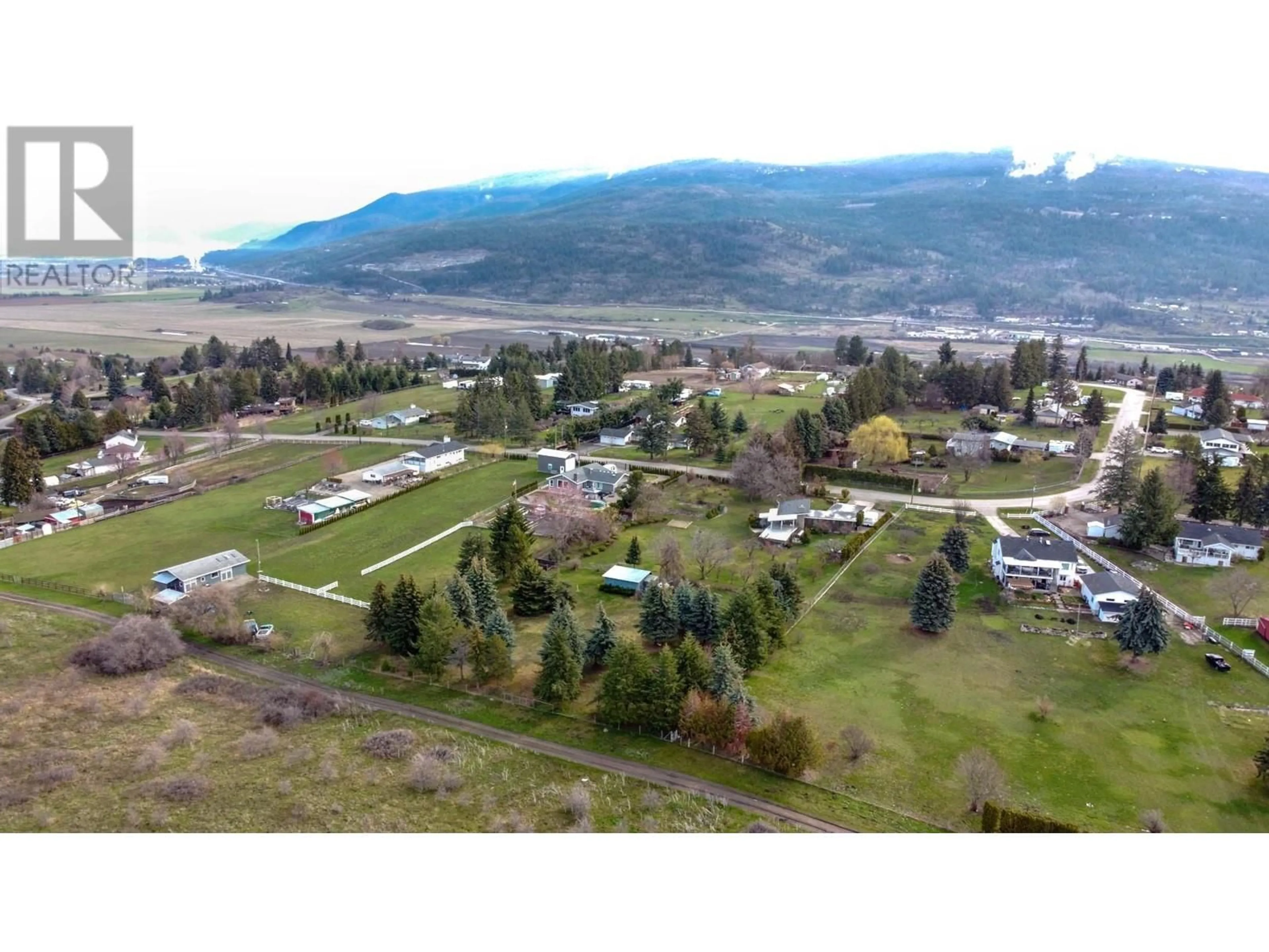 A pic from outside/outdoor area/front of a property/back of a property/a pic from drone, mountain view for 218 STEPPING STONE CRESCENT, Spallumcheen British Columbia V1H1X2