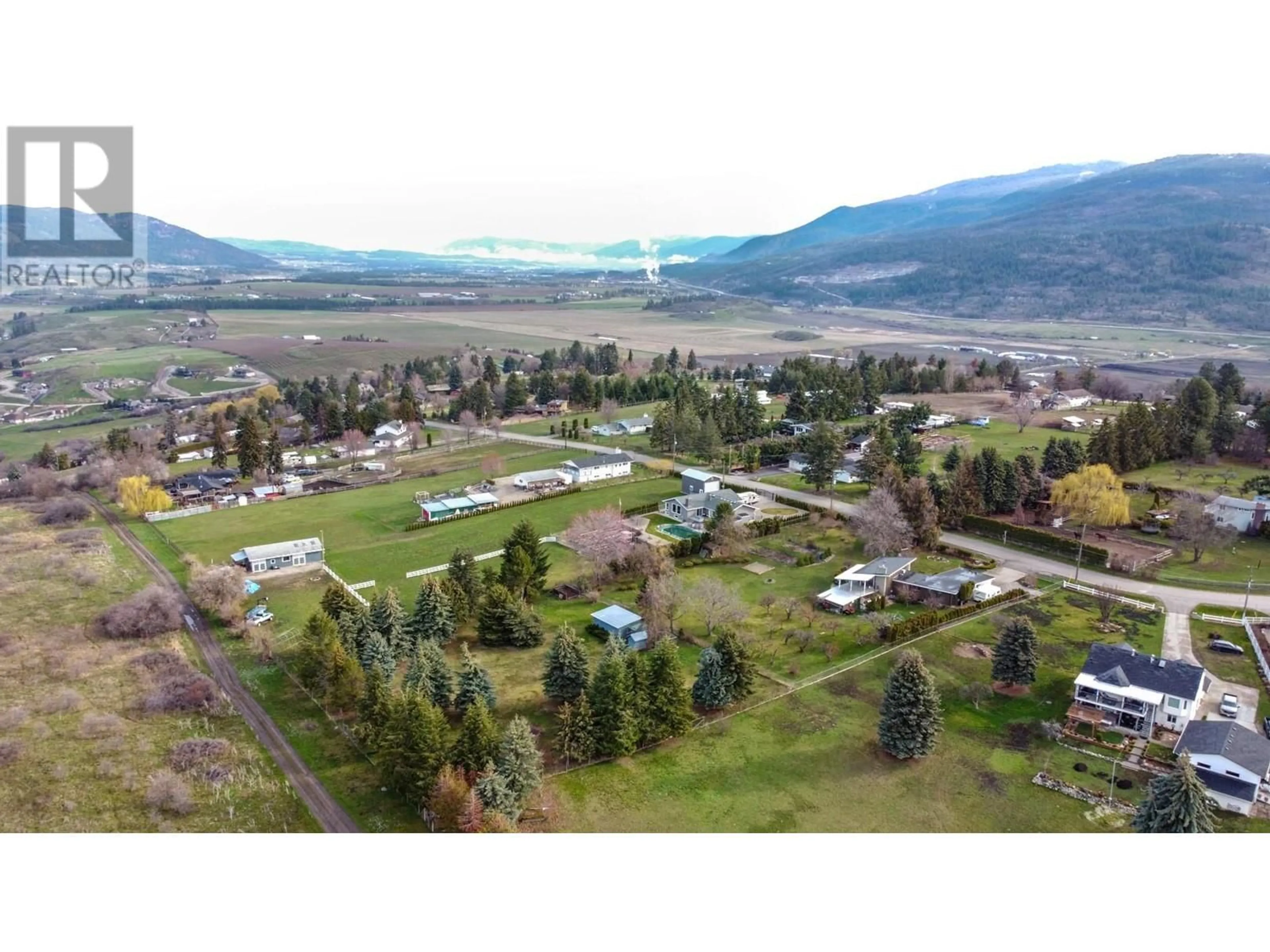A pic from outside/outdoor area/front of a property/back of a property/a pic from drone, mountain view for 218 STEPPING STONE CRESCENT, Spallumcheen British Columbia V1H1X2