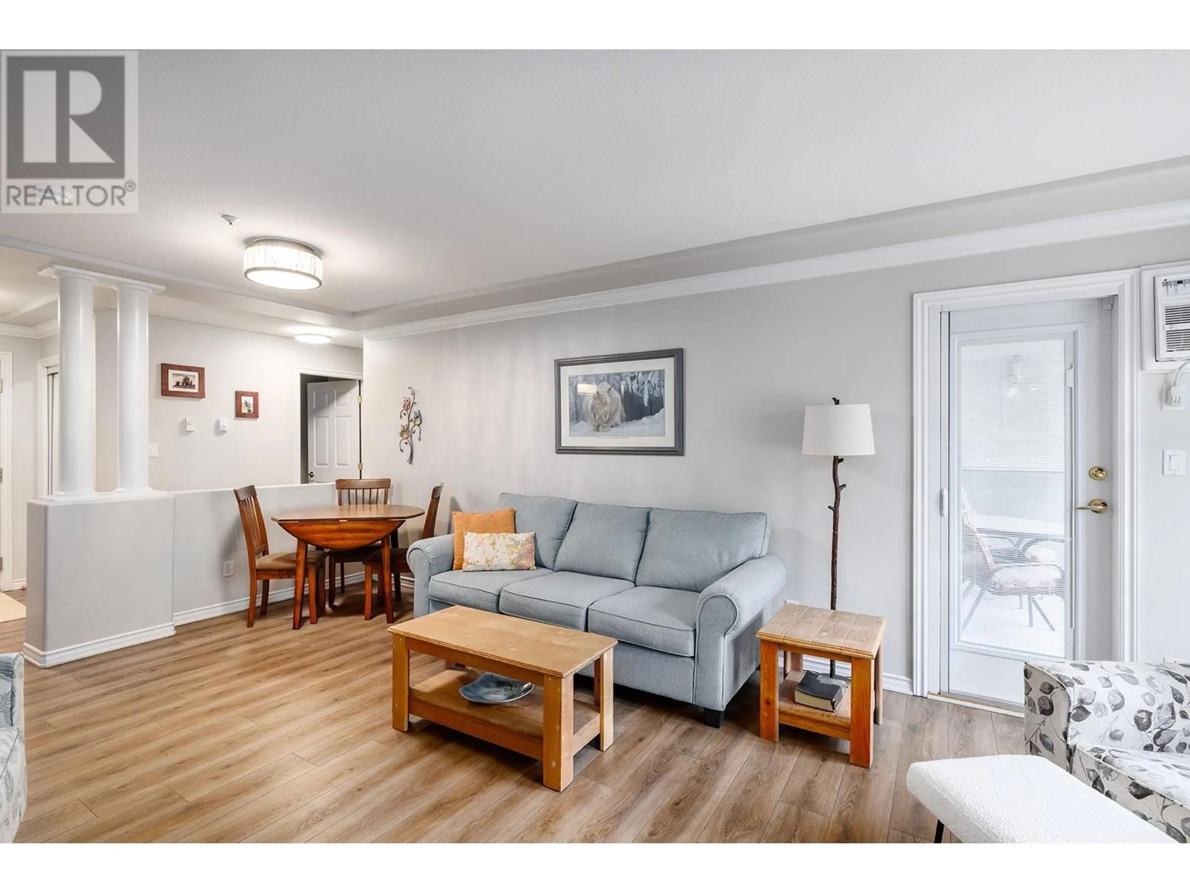 Living room with furniture, wood/laminate floor for 112 - 3300 CENTENNIAL DRIVE, Vernon British Columbia V1T9M5