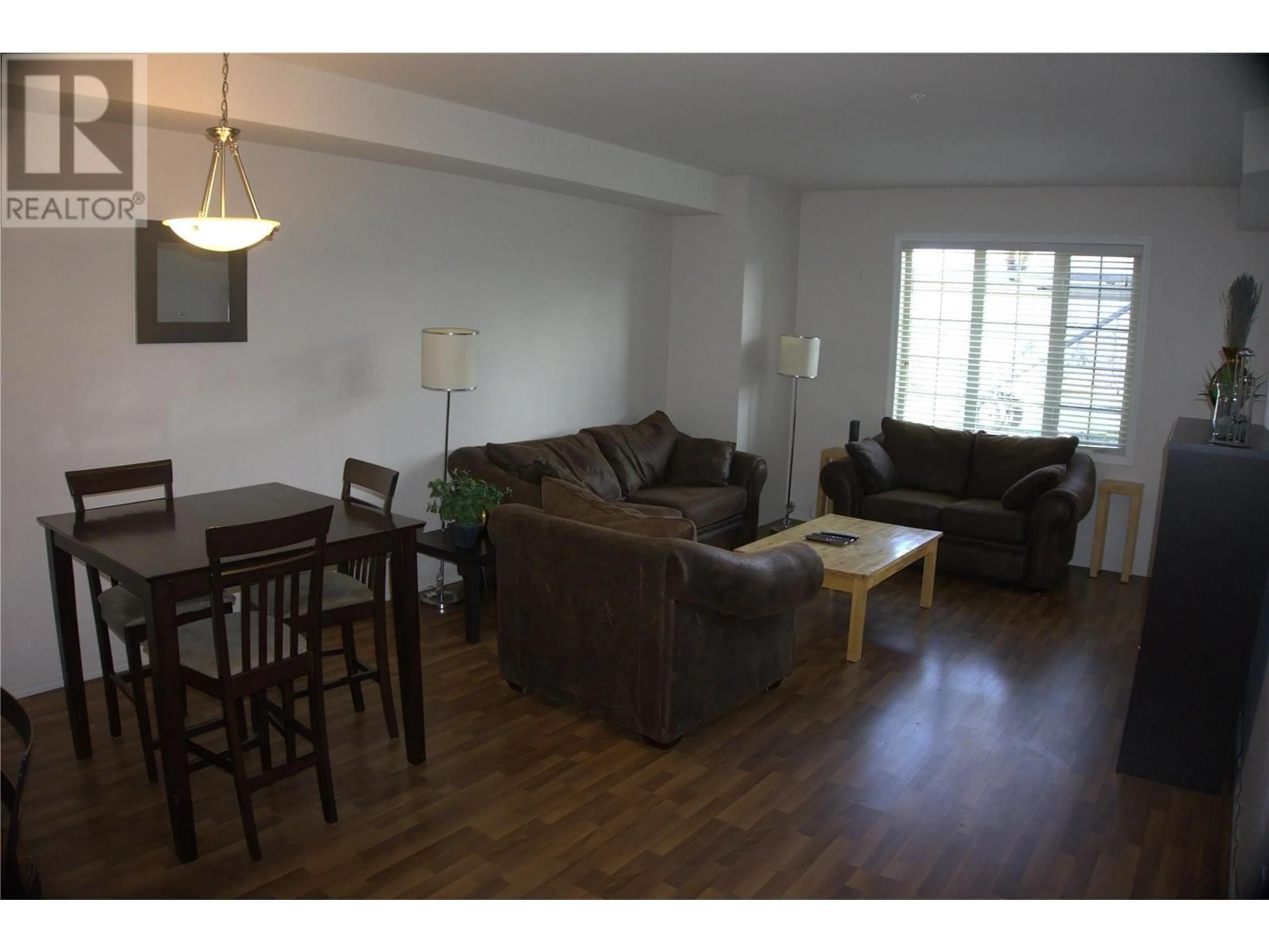 Living room with furniture, wood/laminate floor for 1318 - 1875 COUNTRY CLUB DRIVE, Kelowna British Columbia V1V2W7
