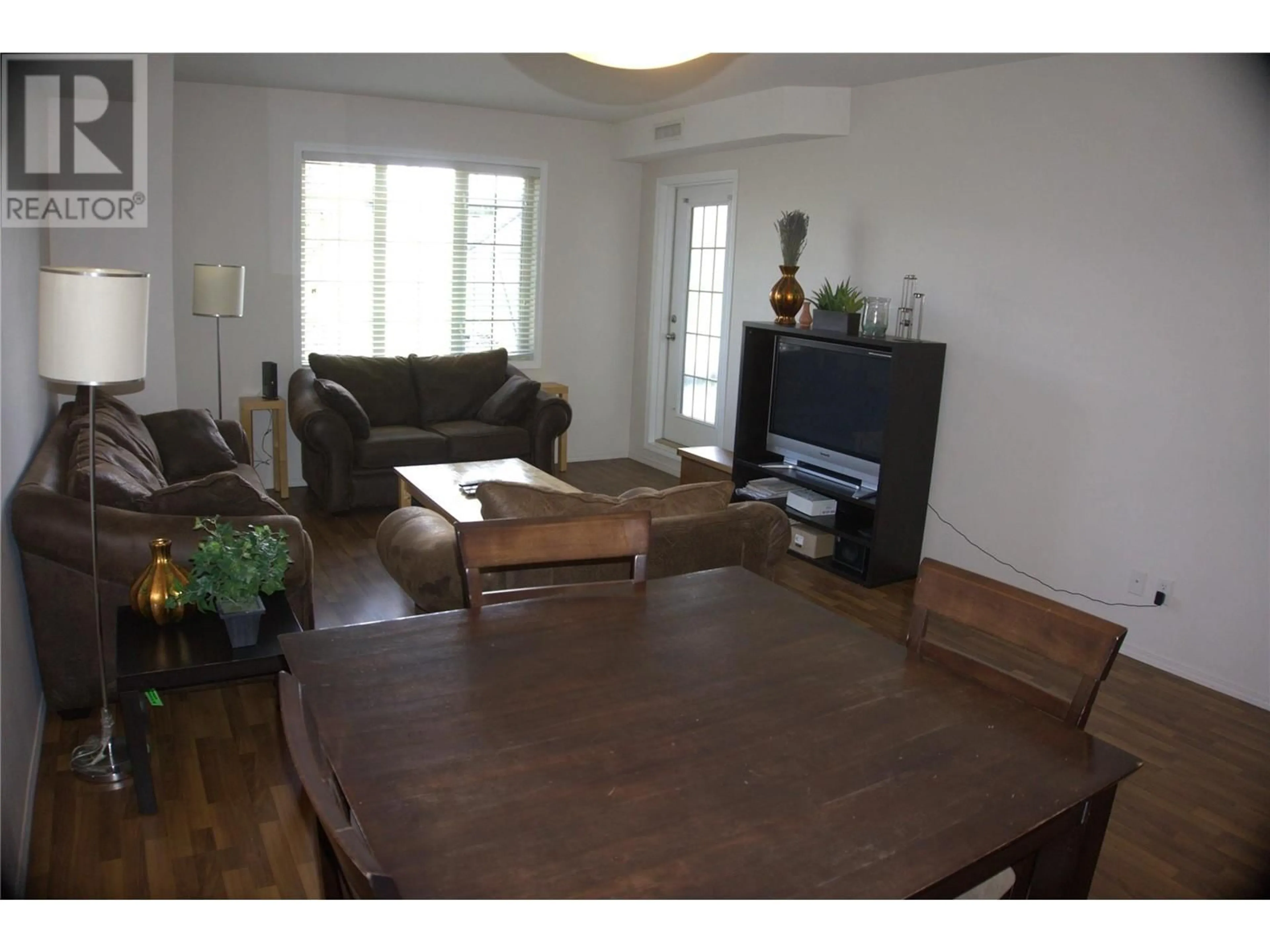 Living room with furniture, wood/laminate floor for 1318 - 1875 COUNTRY CLUB DRIVE, Kelowna British Columbia V1V2W7