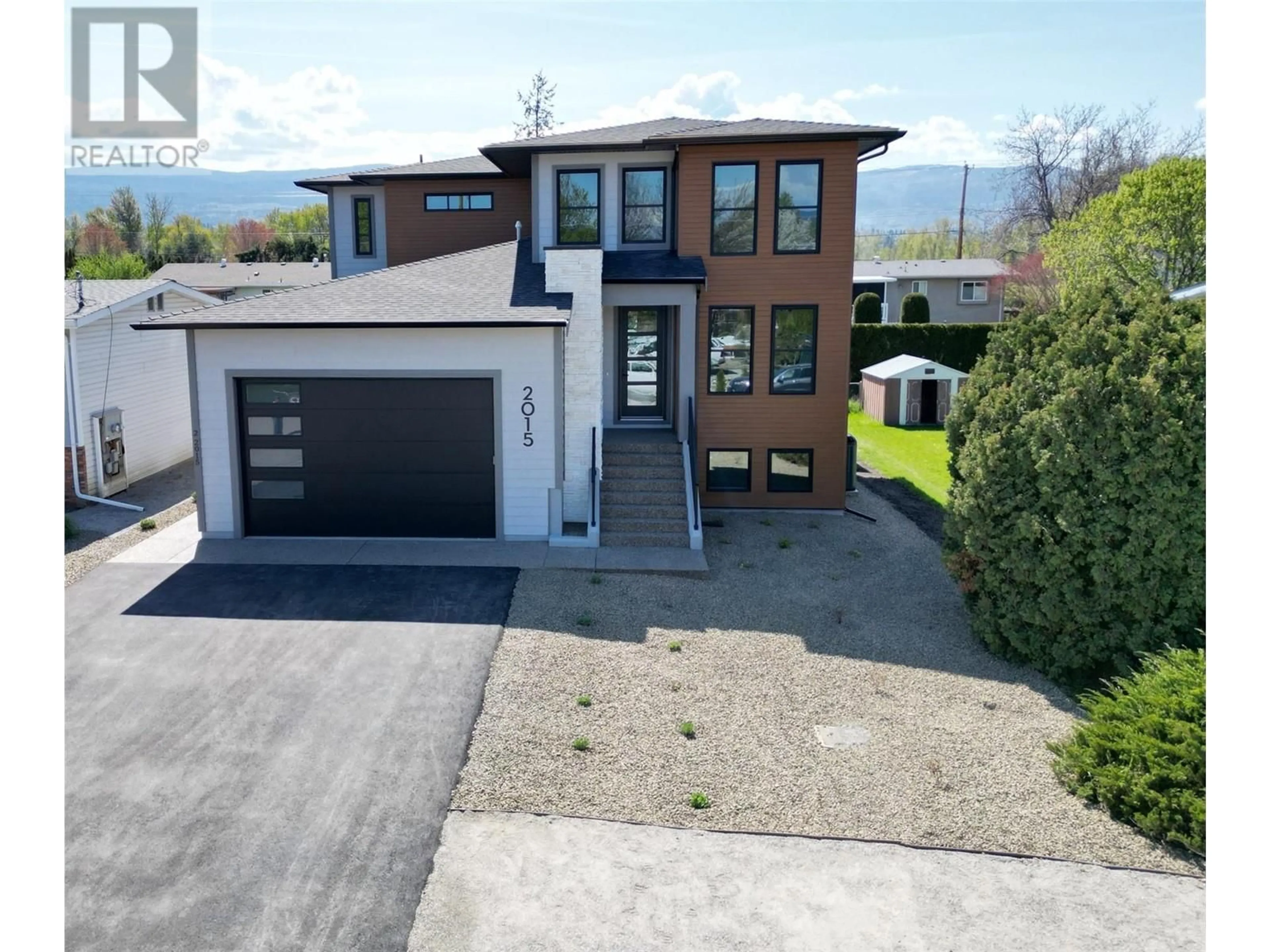 A pic from outside/outdoor area/front of a property/back of a property/a pic from drone, street for 2015 POLO ROAD, Kelowna British Columbia V1W2H5