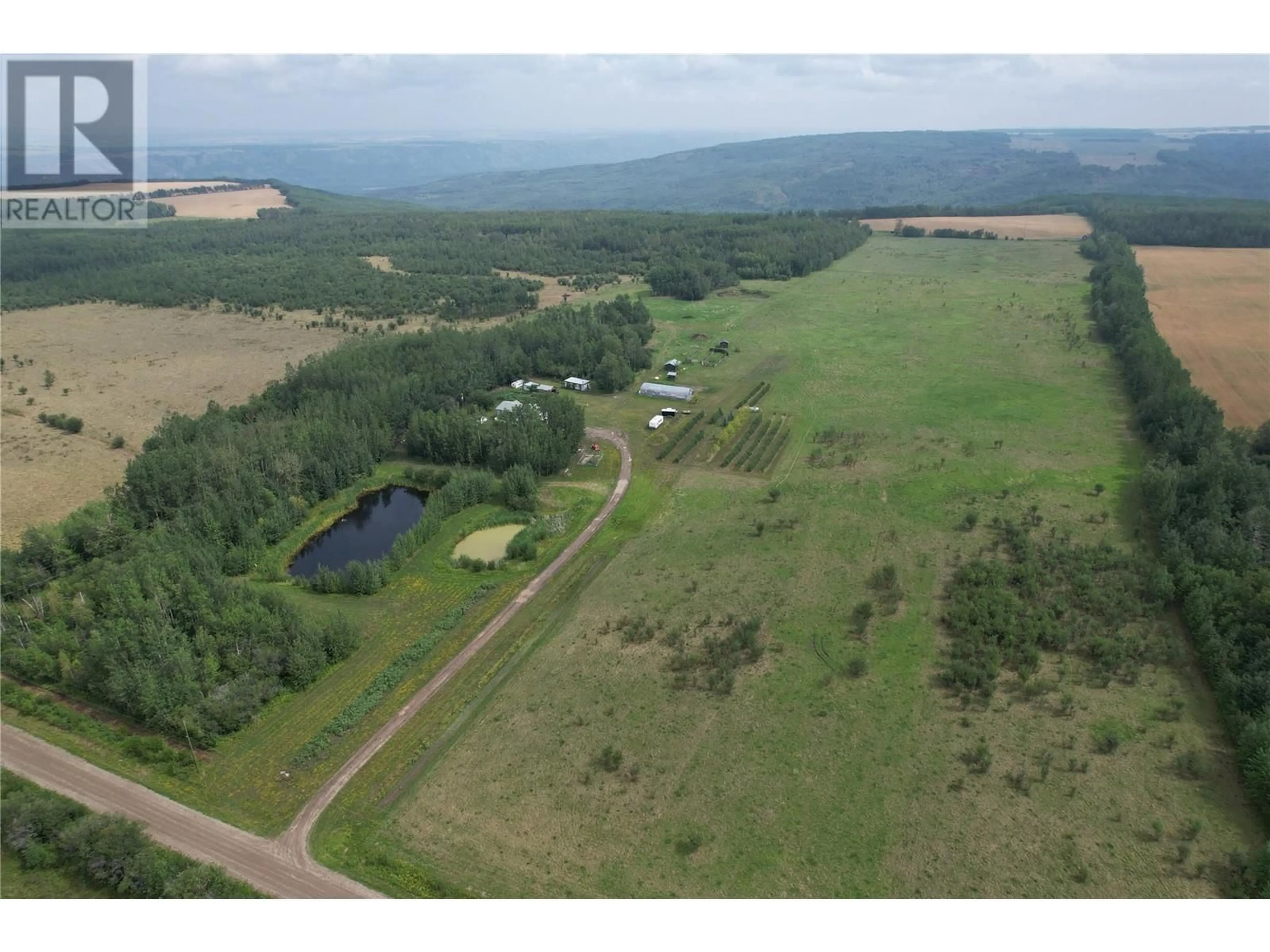 A pic from outside/outdoor area/front of a property/back of a property/a pic from drone, water/lake/river/ocean view for 2770 241 ROAD, Dawson Creek British Columbia V0C2K0