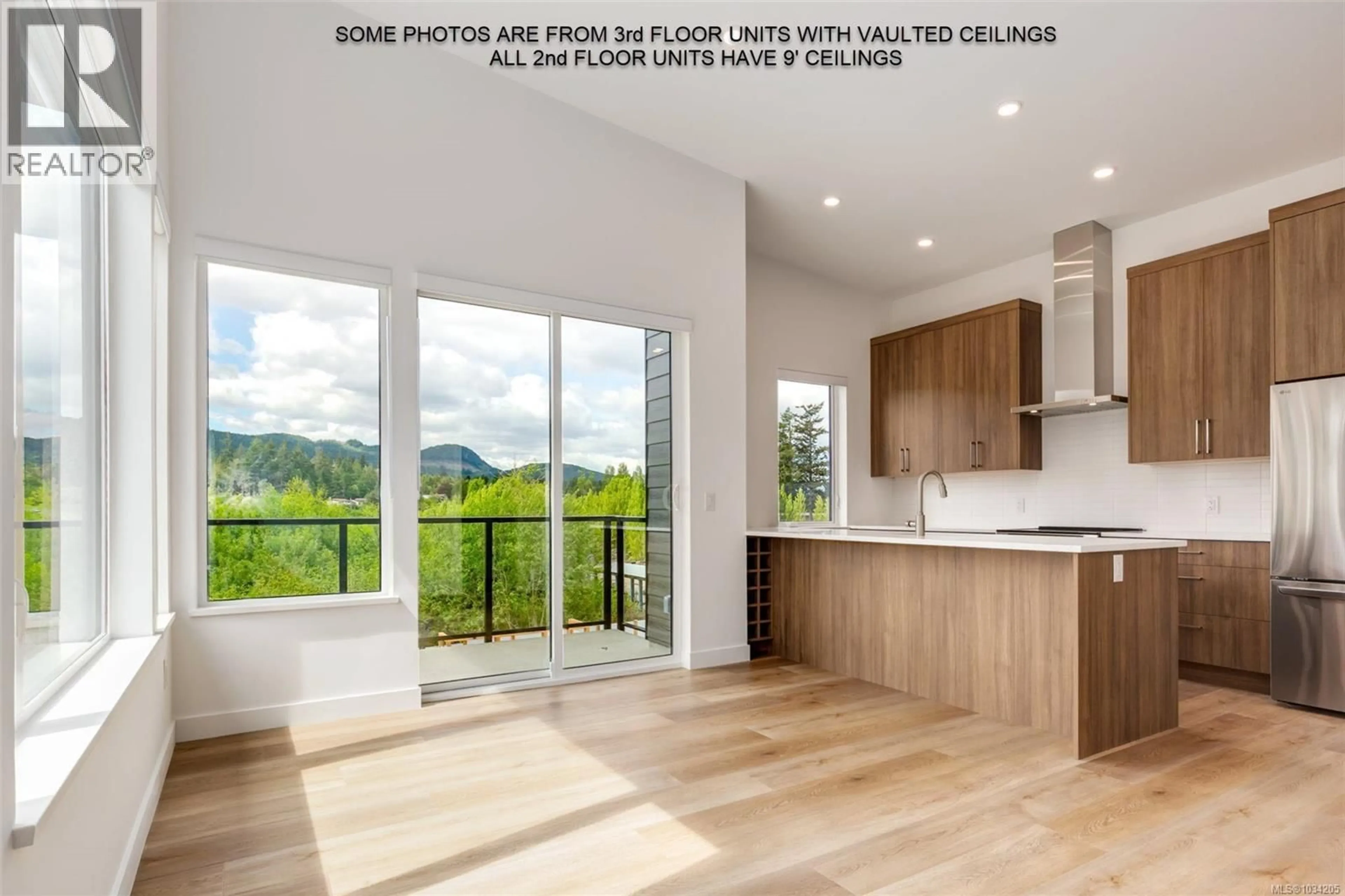 Open concept kitchen, wood/laminate floor for 205 - 7181 LANTZVILLE ROAD, Lantzville British Columbia V0R2H0