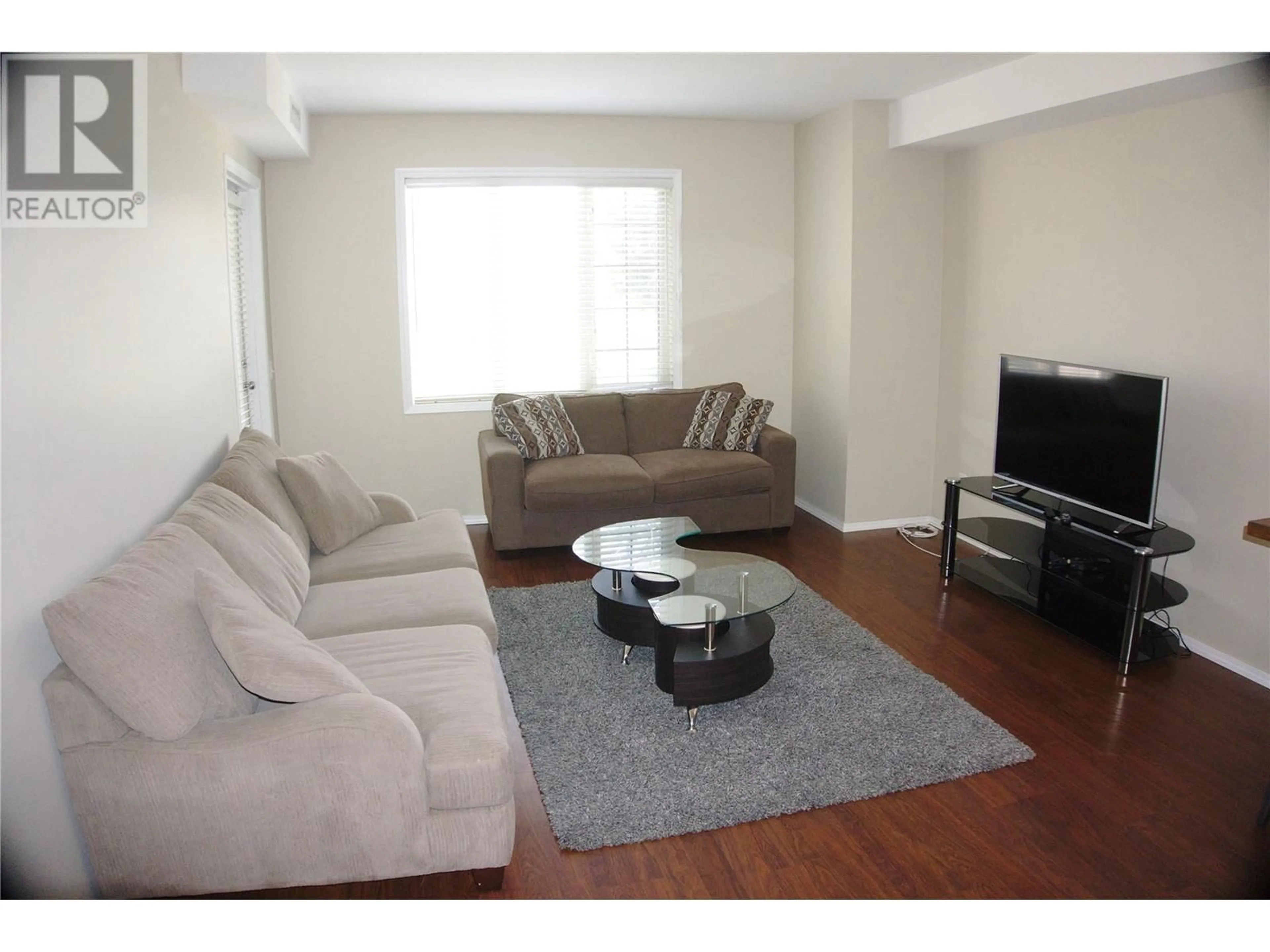 Living room with furniture, wood/laminate floor for 1316 - 1875 COUNTRY CLUB DRIVE, Kelowna British Columbia V1V2W7