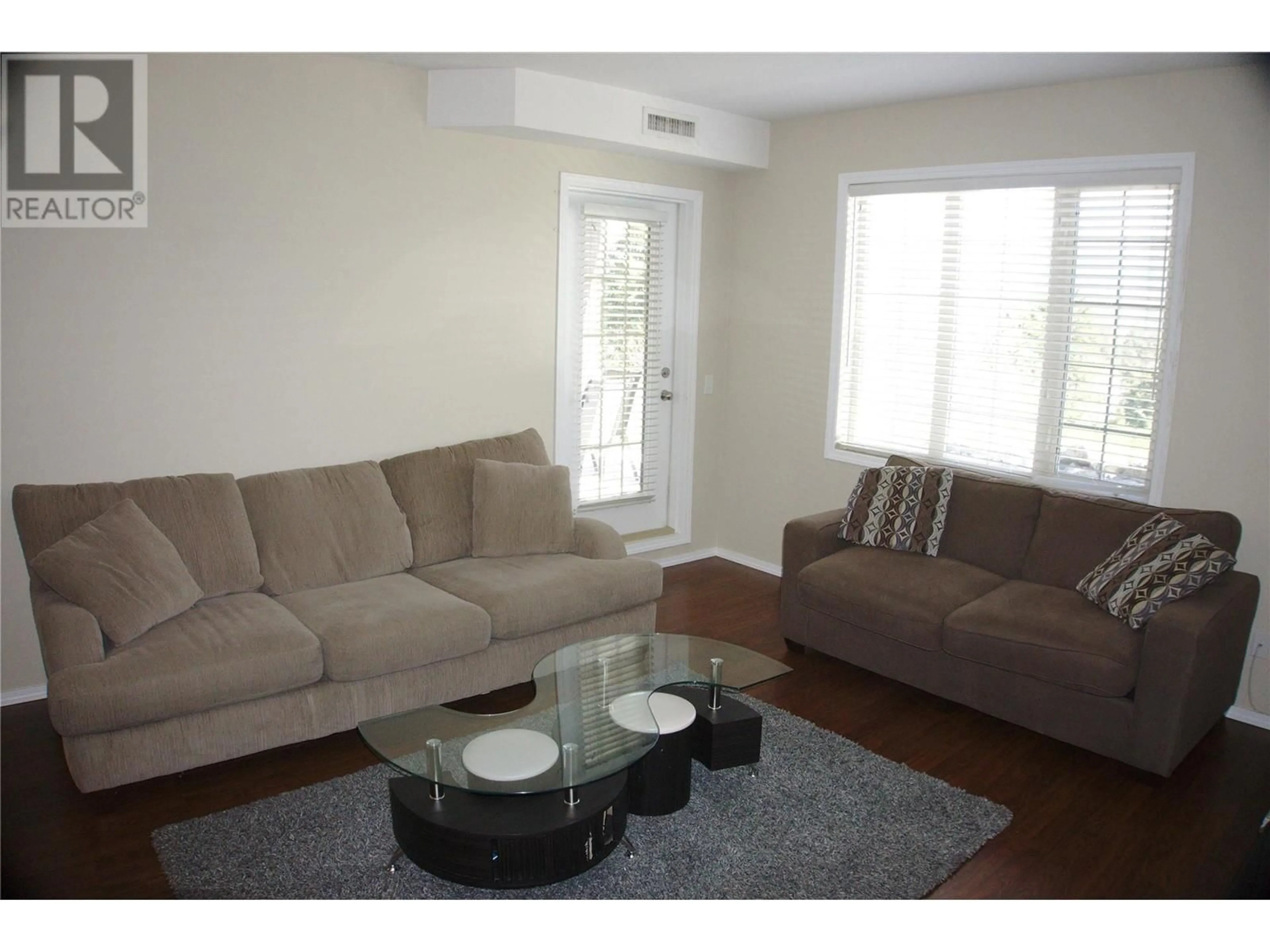 Living room with furniture, wood/laminate floor for 1316 - 1875 COUNTRY CLUB DRIVE, Kelowna British Columbia V1V2W7