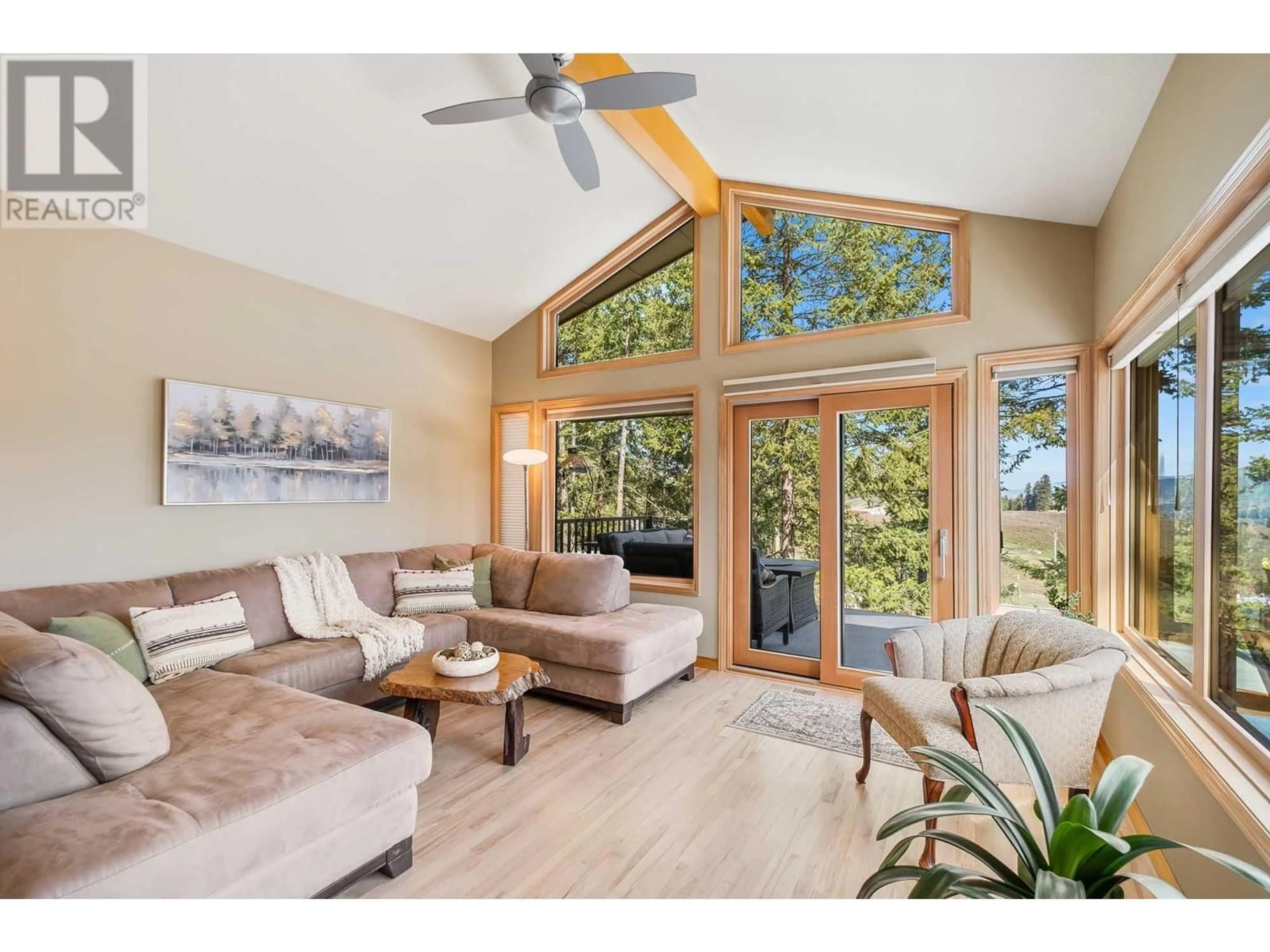 Living room with furniture, wood/laminate floor for 10574 LONG ROAD, Lake Country British Columbia V4V1N7