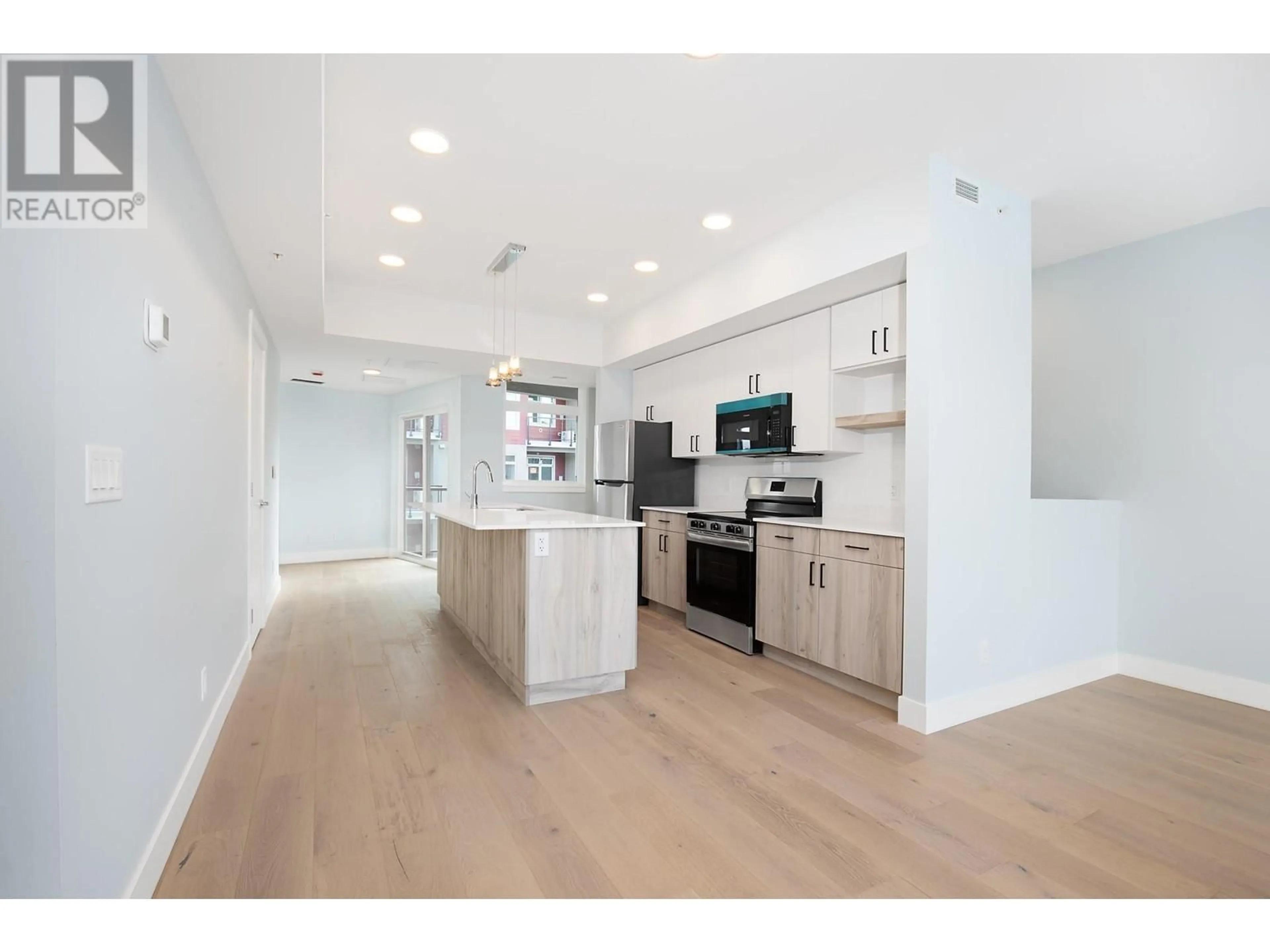 Open concept kitchen, wood/laminate floor for 402 - 215 ROYAL AVENUE, Kamloops British Columbia V2H1T7
