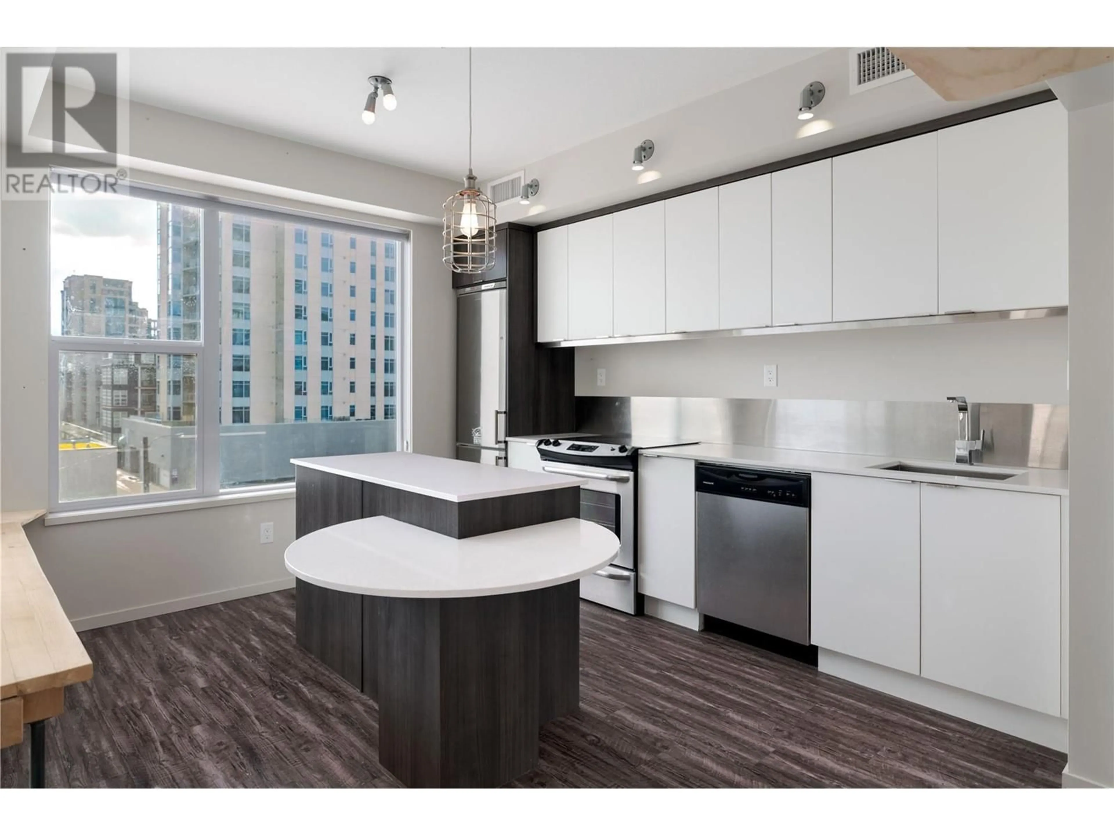 Open concept kitchen, wood/laminate floor for 413 - 1290 ST PAUL STREET, Kelowna British Columbia V1Y2C9