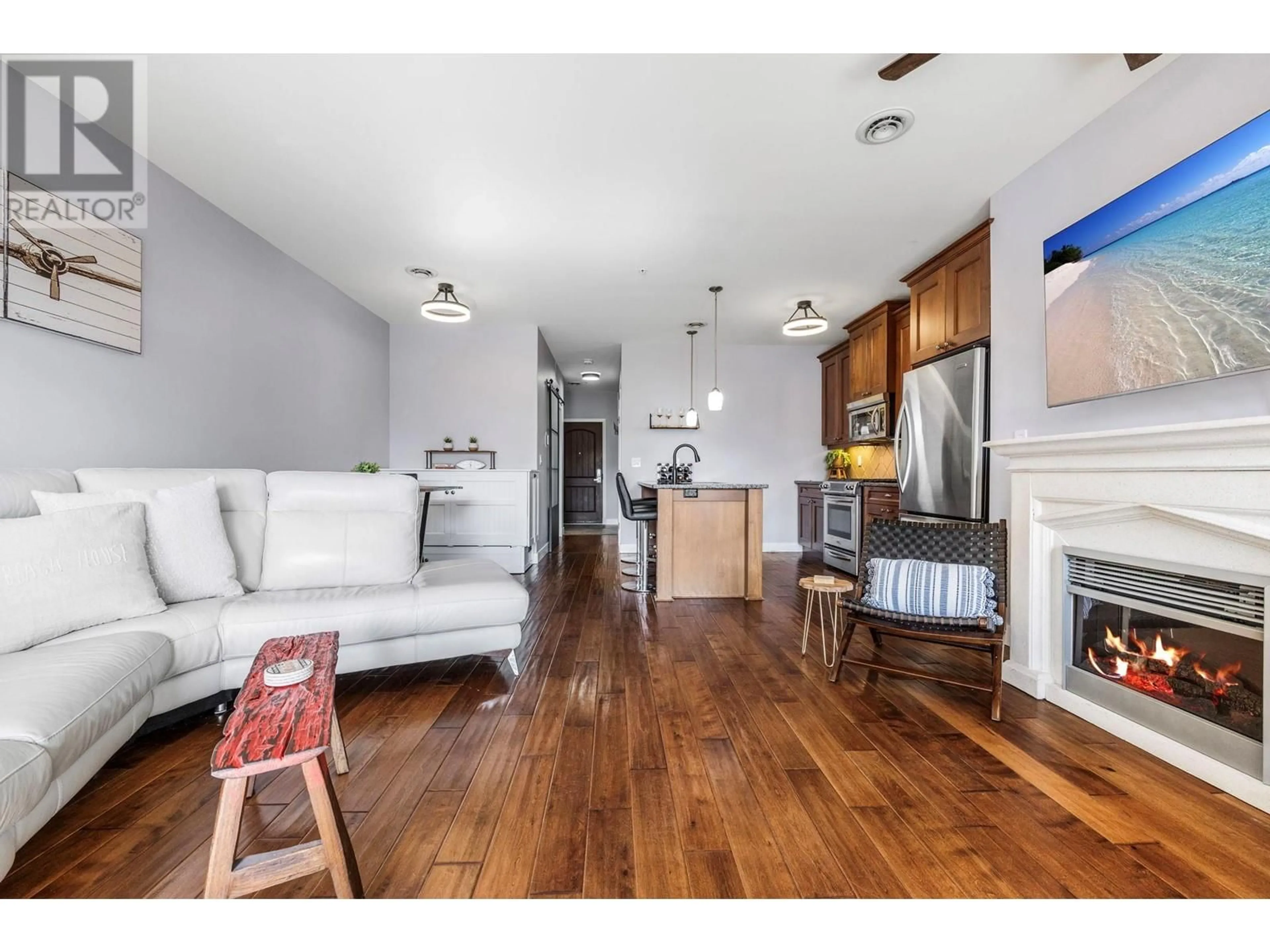Living room with furniture, wood/laminate floor for 8205 - 4028 PRITCHARD DRIVE, West Kelowna British Columbia V4T2N6