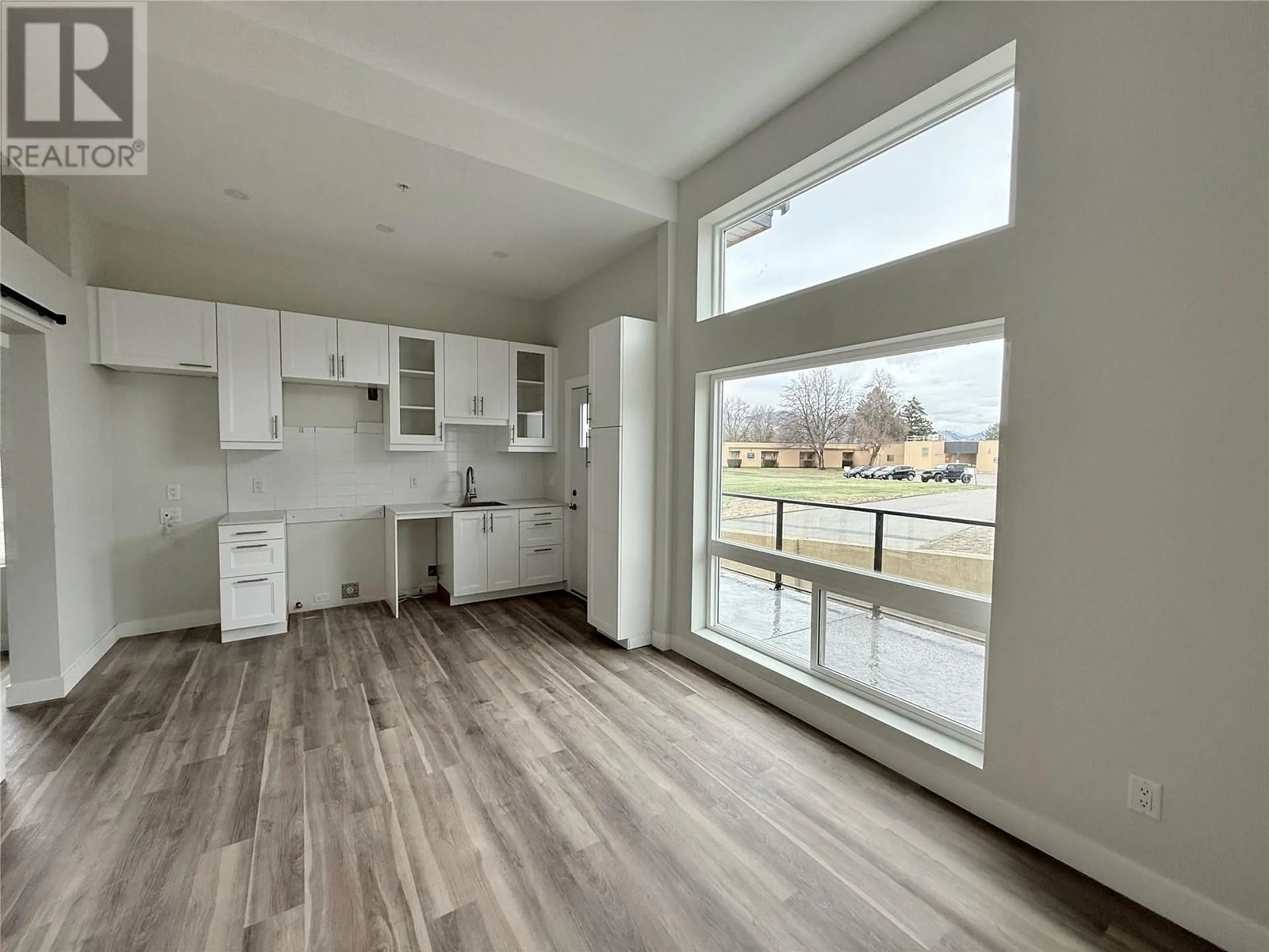 Open concept kitchen, wood/laminate floor for 104 - 937 SPILLWAY ROAD, Oliver British Columbia V0H1T8