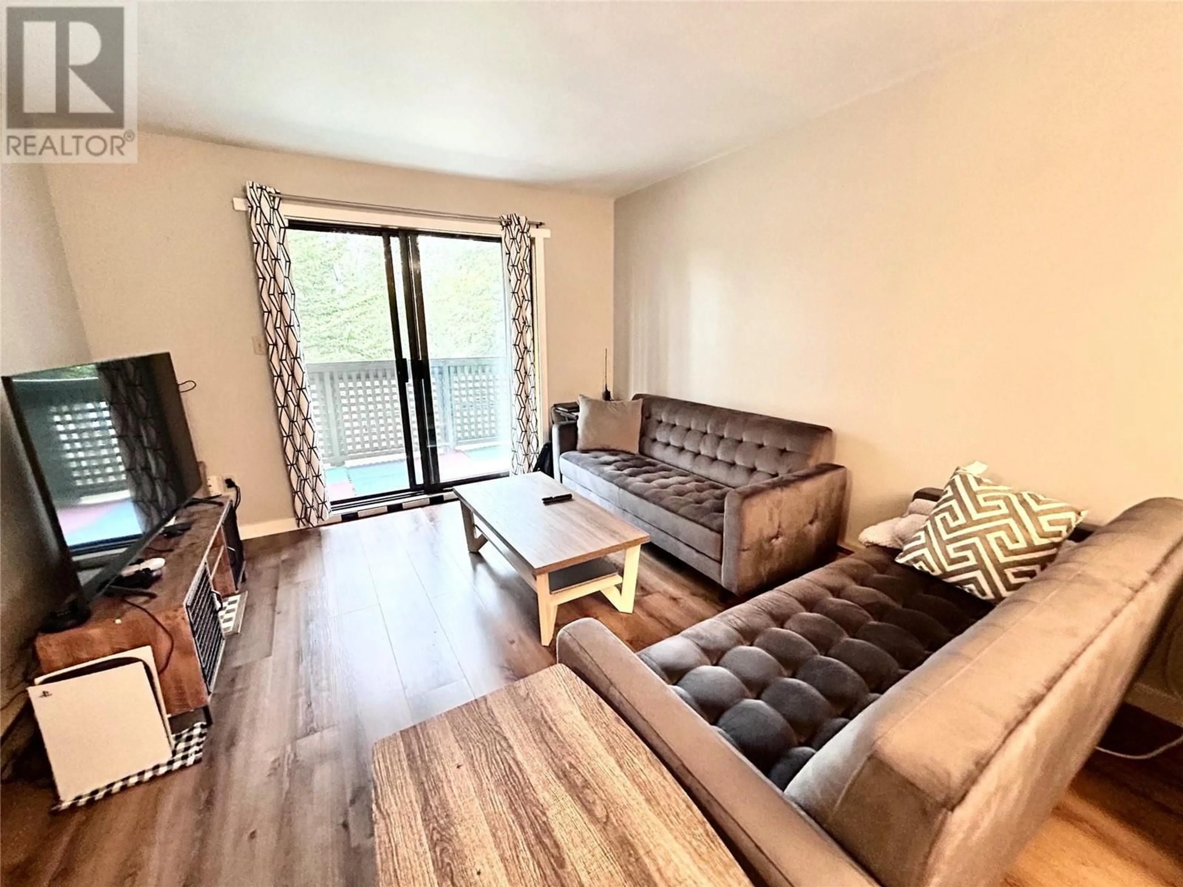 Living room with furniture, wood/laminate floor for 215 - 185 CHAMBERLAIN CRESCENT, Tumbler Ridge British Columbia V0C2W0