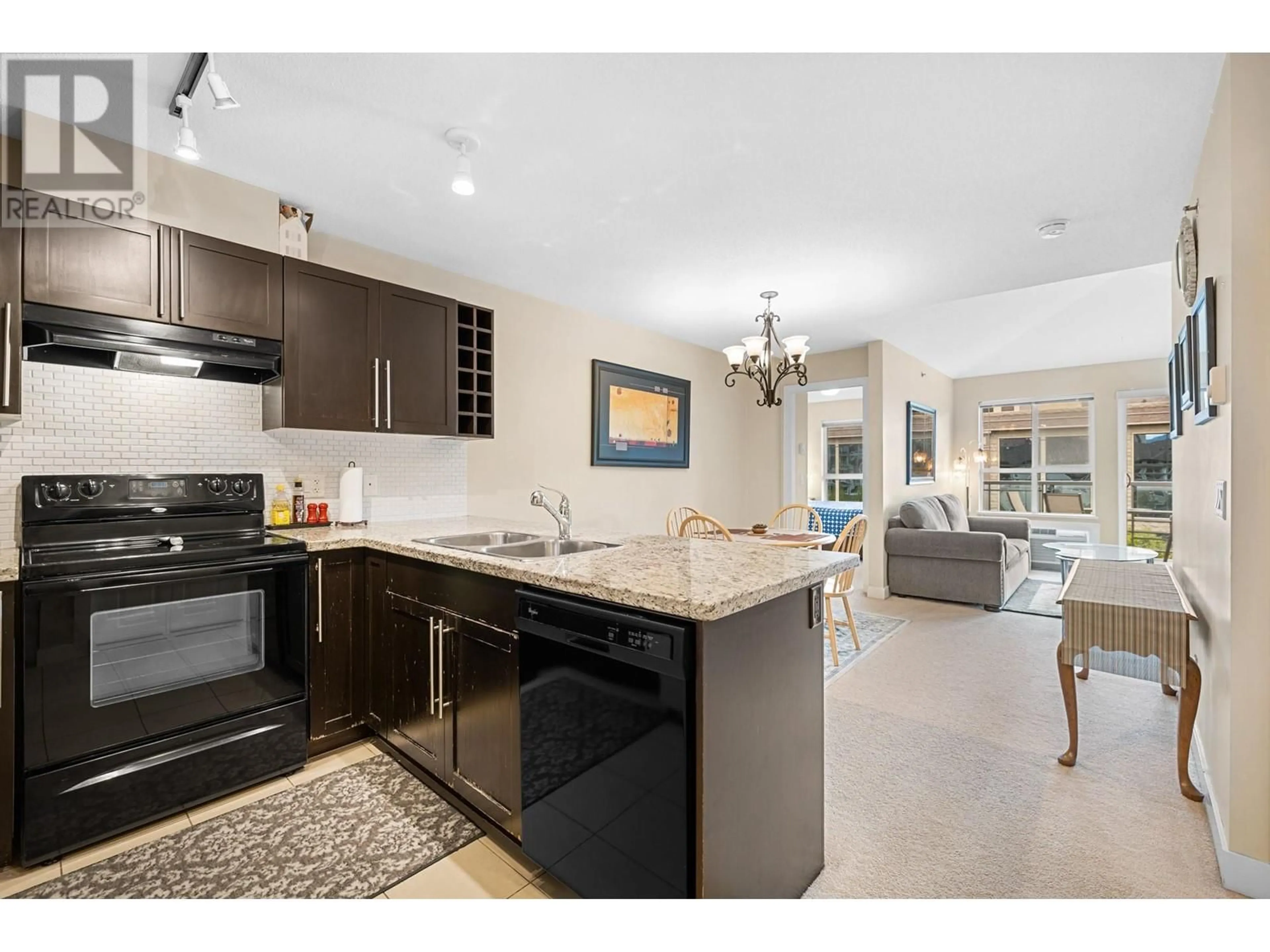Open concept kitchen, ceramic/tile floor for 407 - 1089 SUNSET DRIVE, Kelowna British Columbia V1Y9Z3
