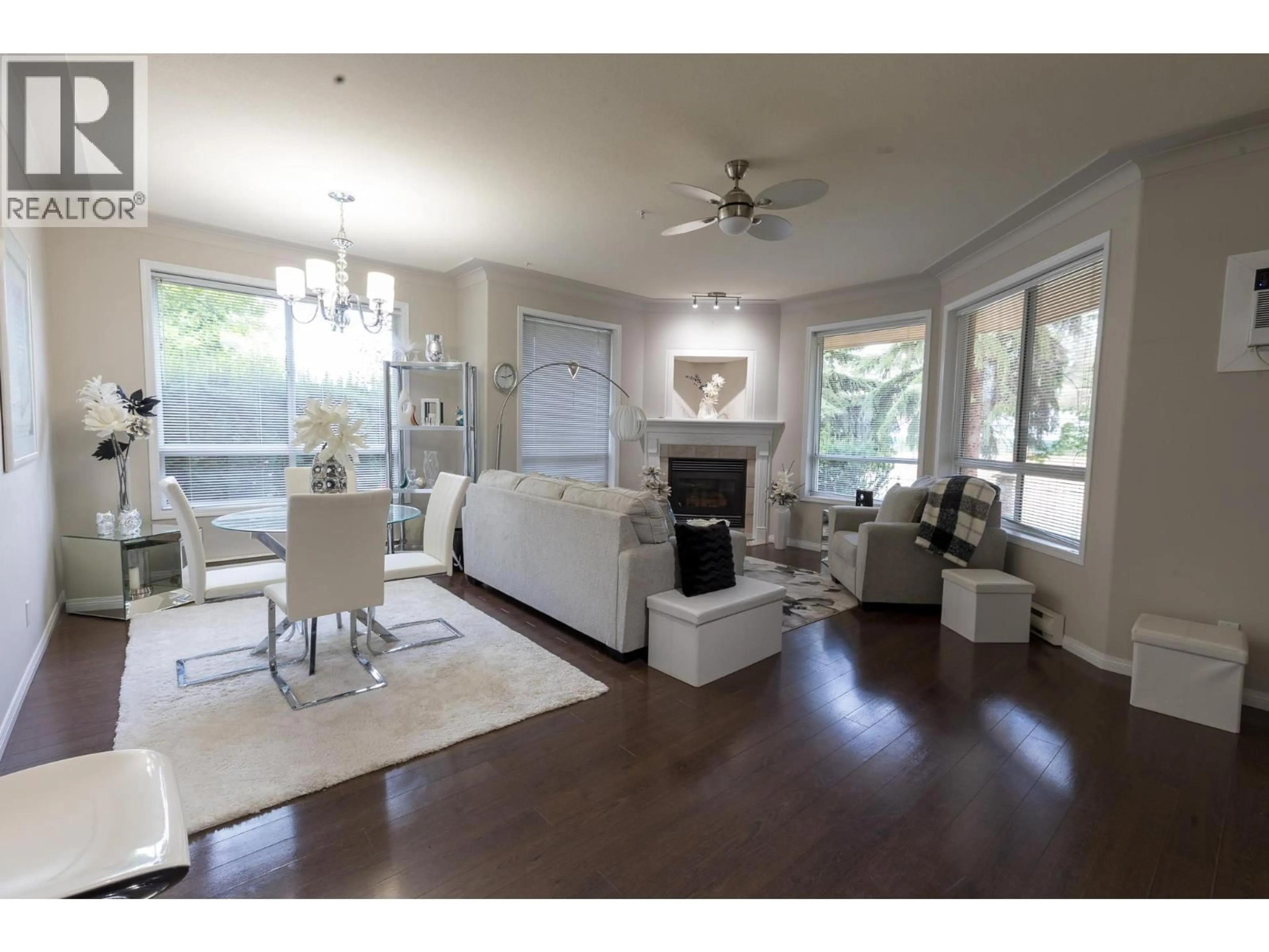 Living room with furniture, wood/laminate floor for 116 - 1964 ENTERPRISE WAY, Kelowna British Columbia V1Y9S7