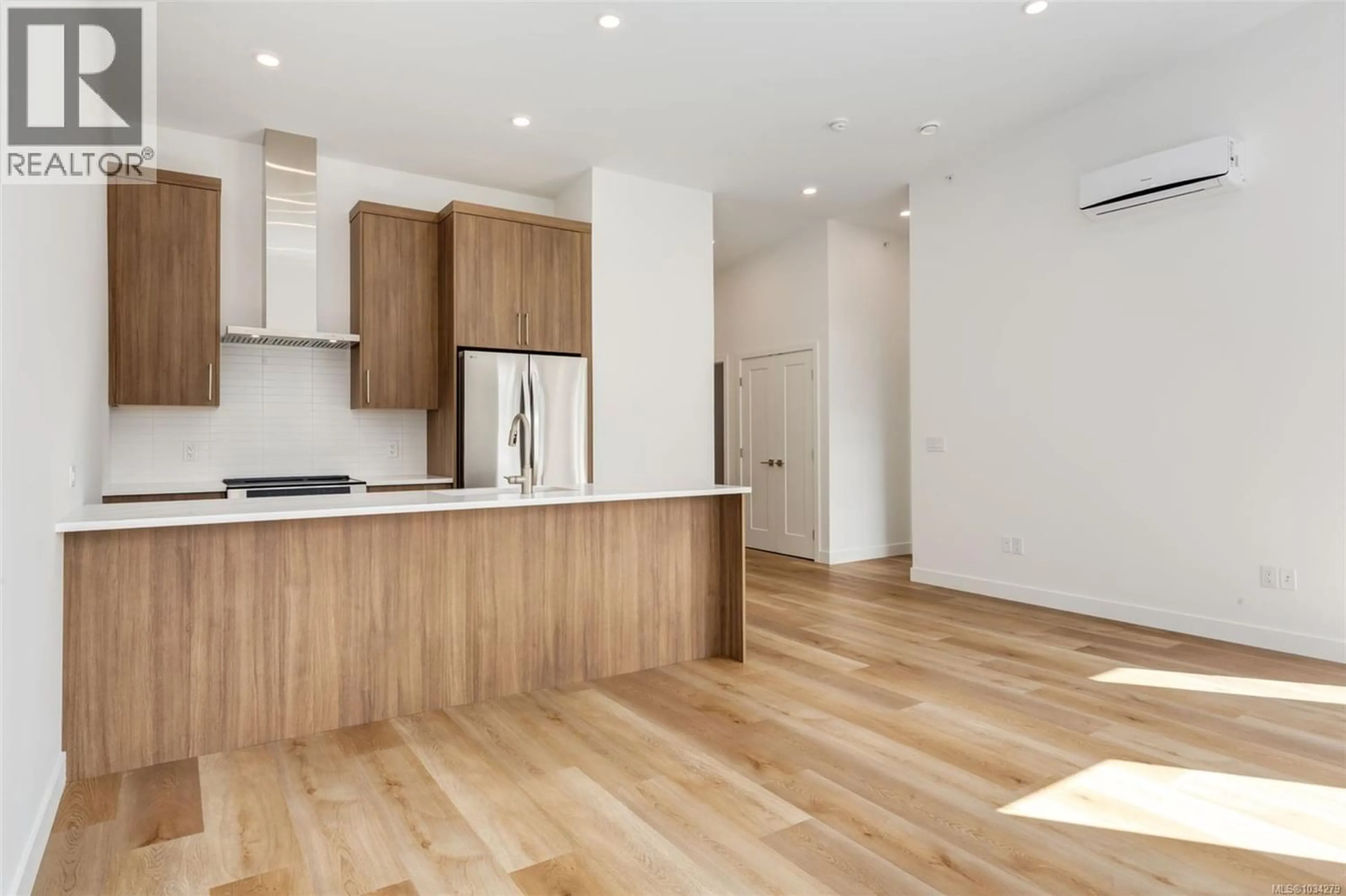 Open concept kitchen, wood/laminate floor for 303 - 7181 LANTZVILLE ROAD, Lantzville British Columbia V0R2H0