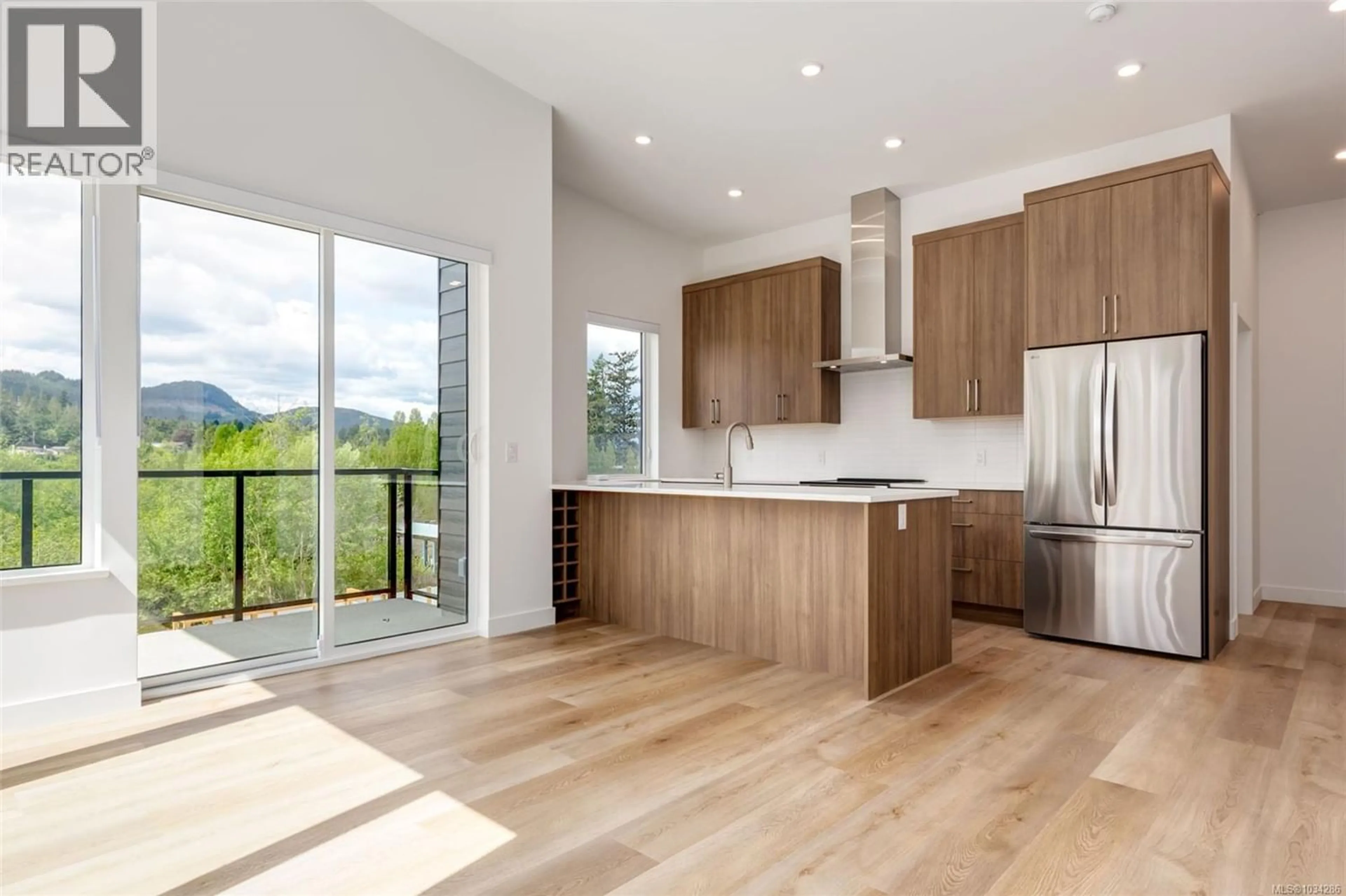 Open concept kitchen, wood/laminate floor for 305 - 7181 LANTZVILLE ROAD, Lantzville British Columbia V0R2H0