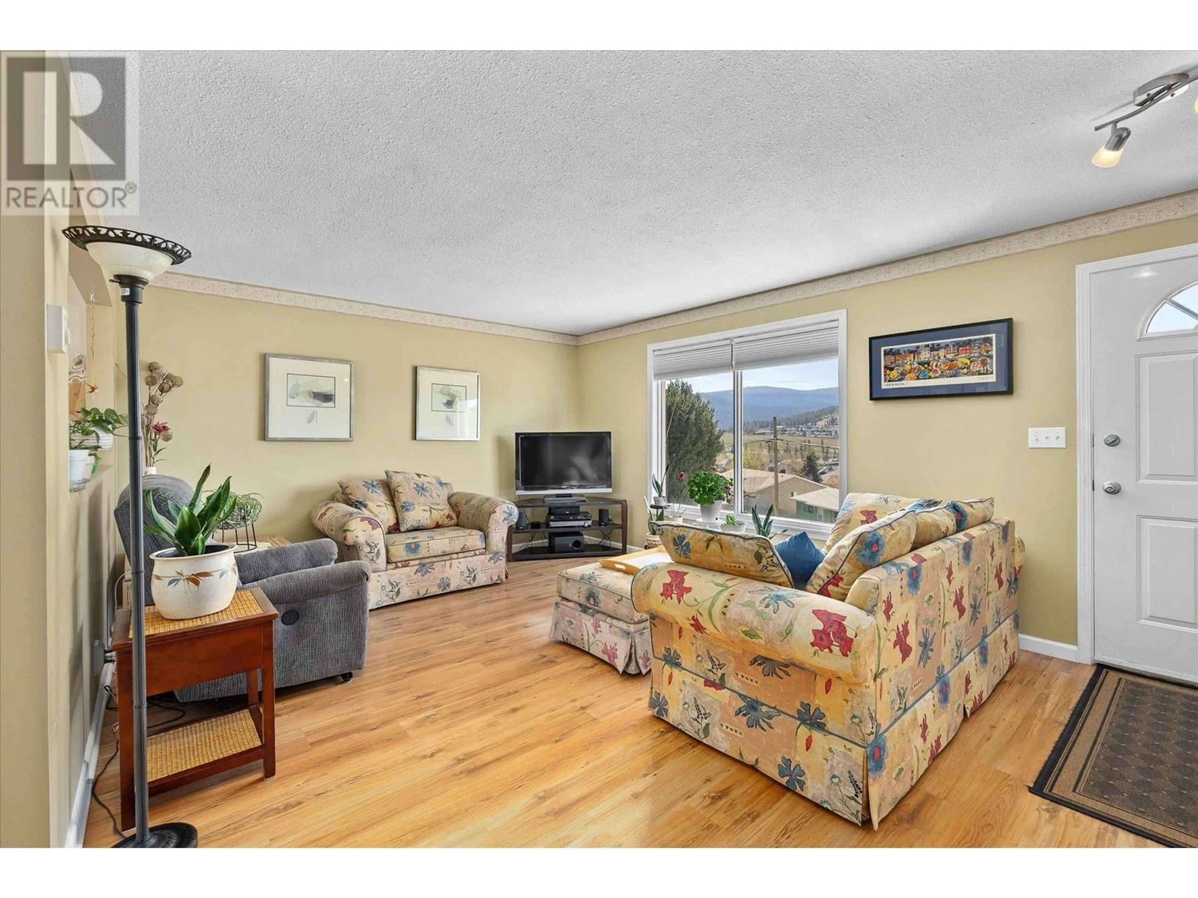 Living room with furniture, wood/laminate floor for 1281 LUND ROAD, Kelowna British Columbia V1P1K9
