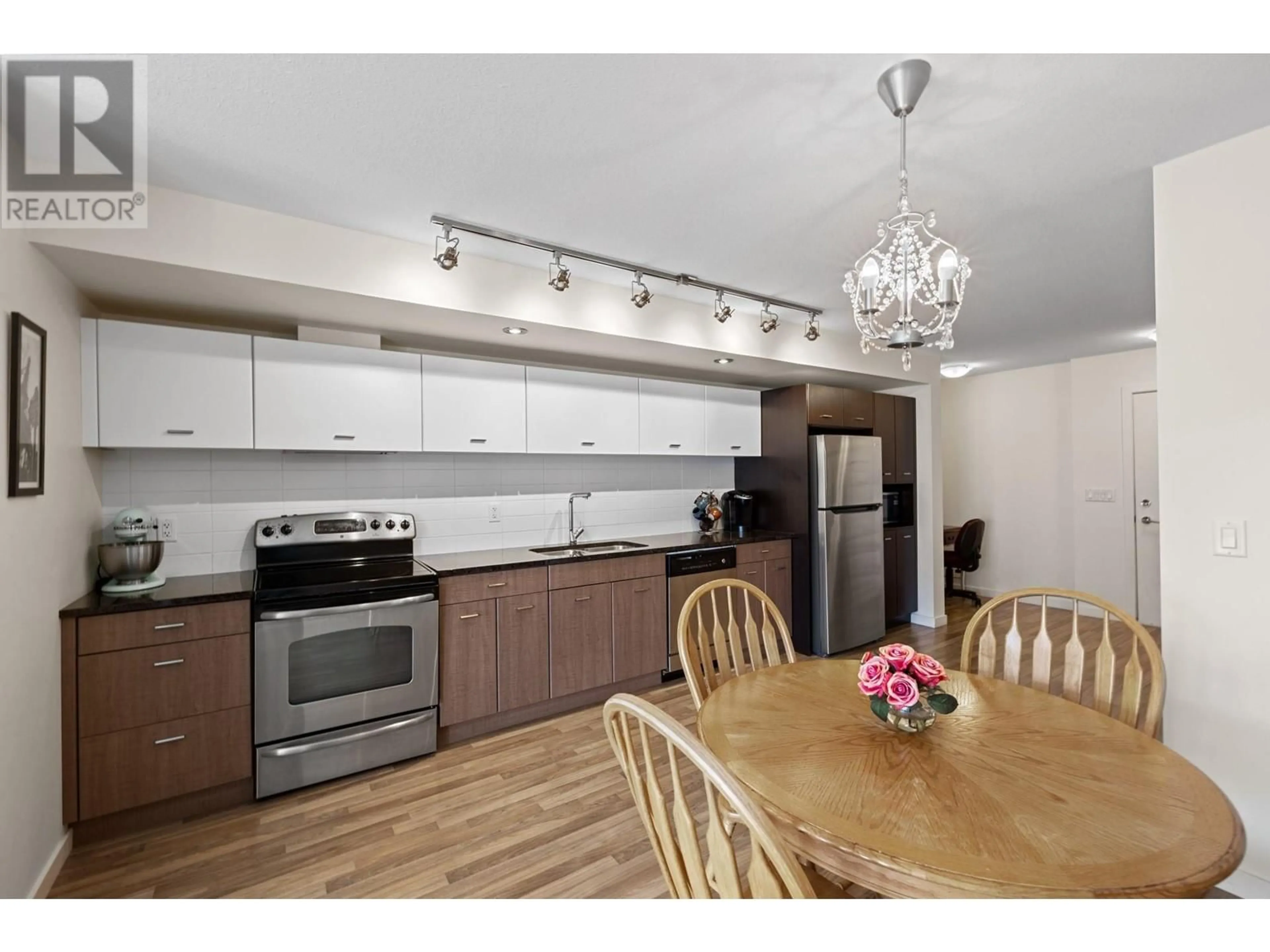Open concept kitchen, wood/laminate floor for 406 - 547 YATES ROAD, Kelowna British Columbia V1V2T9