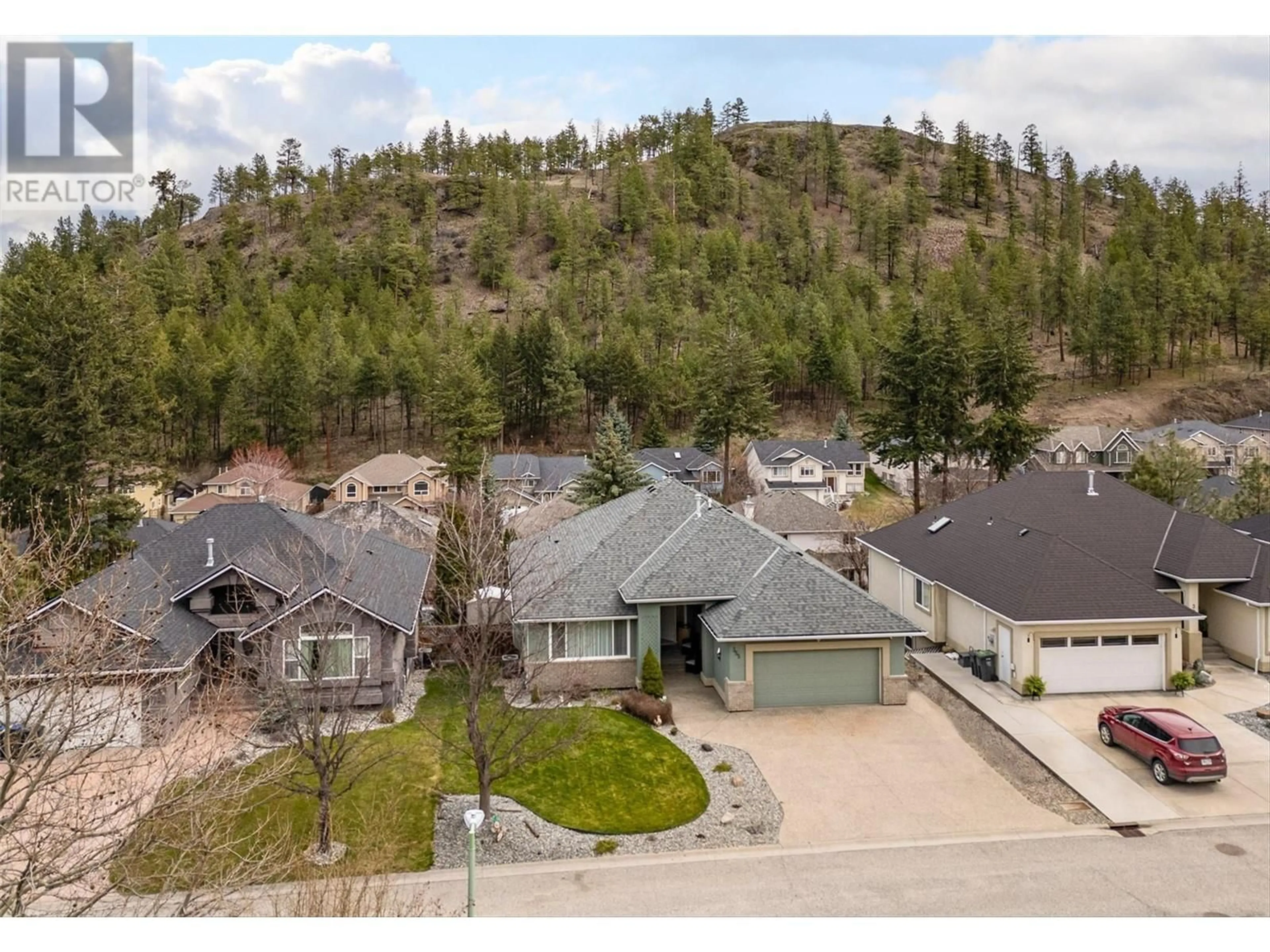 A pic from outside/outdoor area/front of a property/back of a property/a pic from drone, mountain view for 355 WOODPARK CRESCENT, Kelowna British Columbia V1V2L4