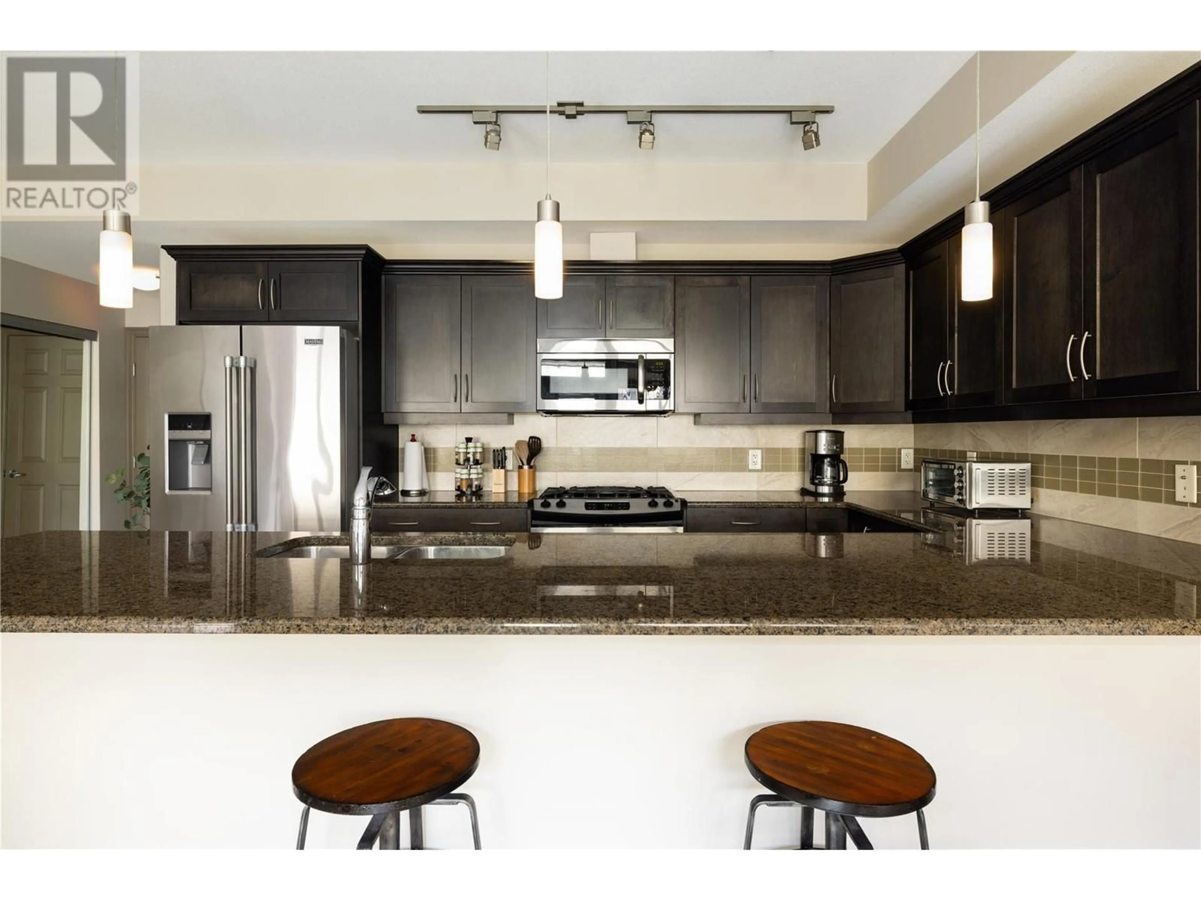 Open concept kitchen, ceramic/tile floor for 205 - 3589 SKAHA LAKE ROAD, Penticton British Columbia V2A7K2