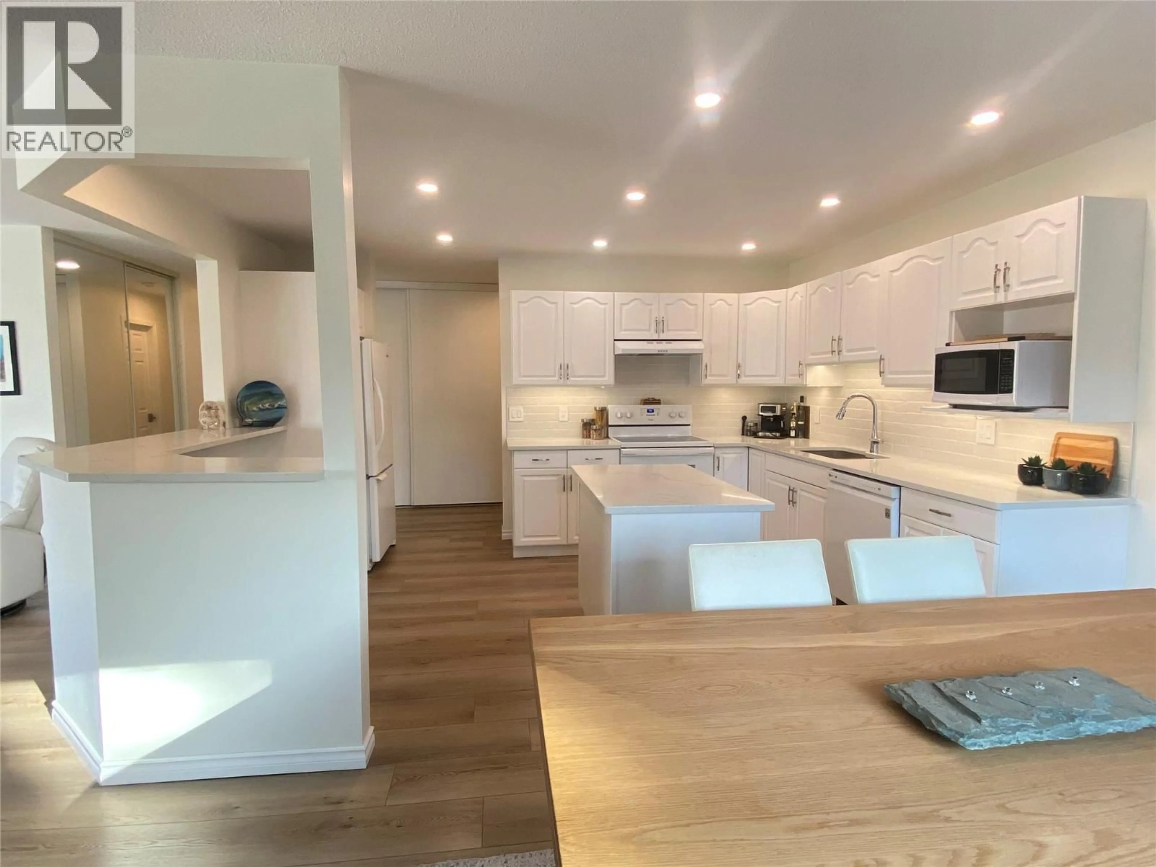Open concept kitchen, wood/laminate floor for 211 - 1249 PACIFIC AVENUE, Kelowna British Columbia V1Y5T5