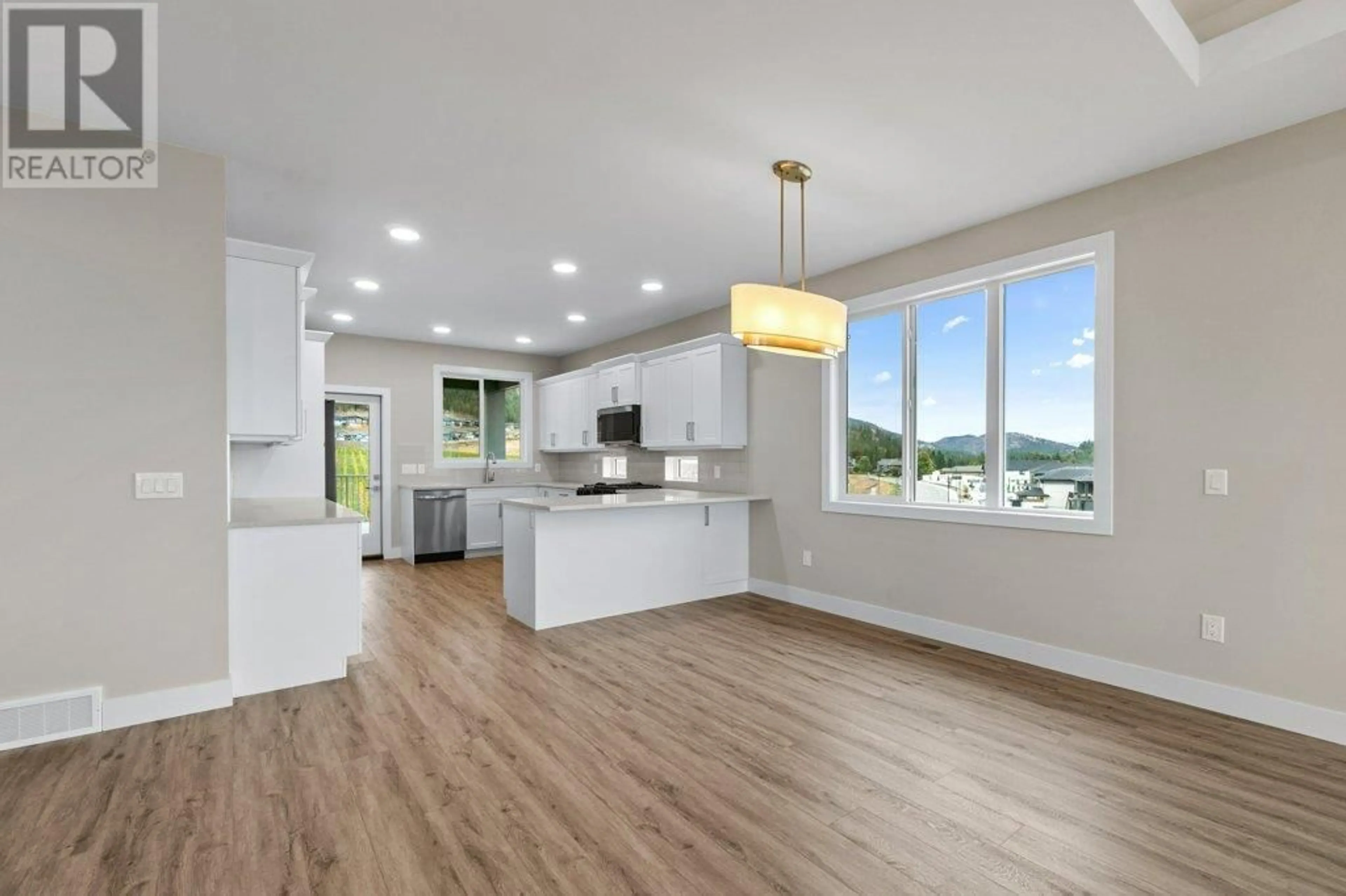 Open concept kitchen, wood/laminate floor for 2542 PINNACLE RIDGE DRIVE, West Kelowna British Columbia V4T0E3