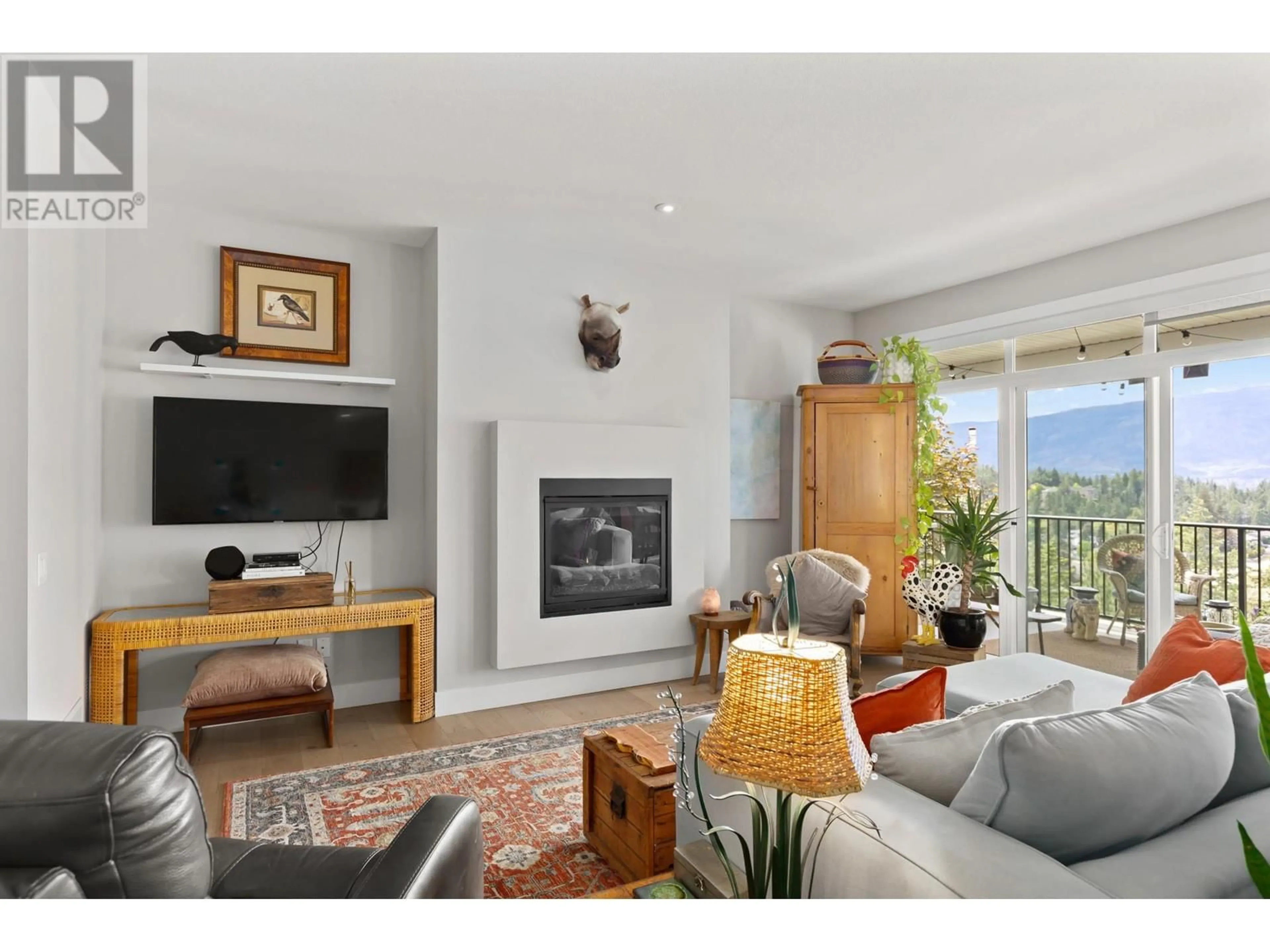 Living room with furniture, wood/laminate floor for 302 UPPER CANYON DRIVE, Kelowna British Columbia V1V2Z8
