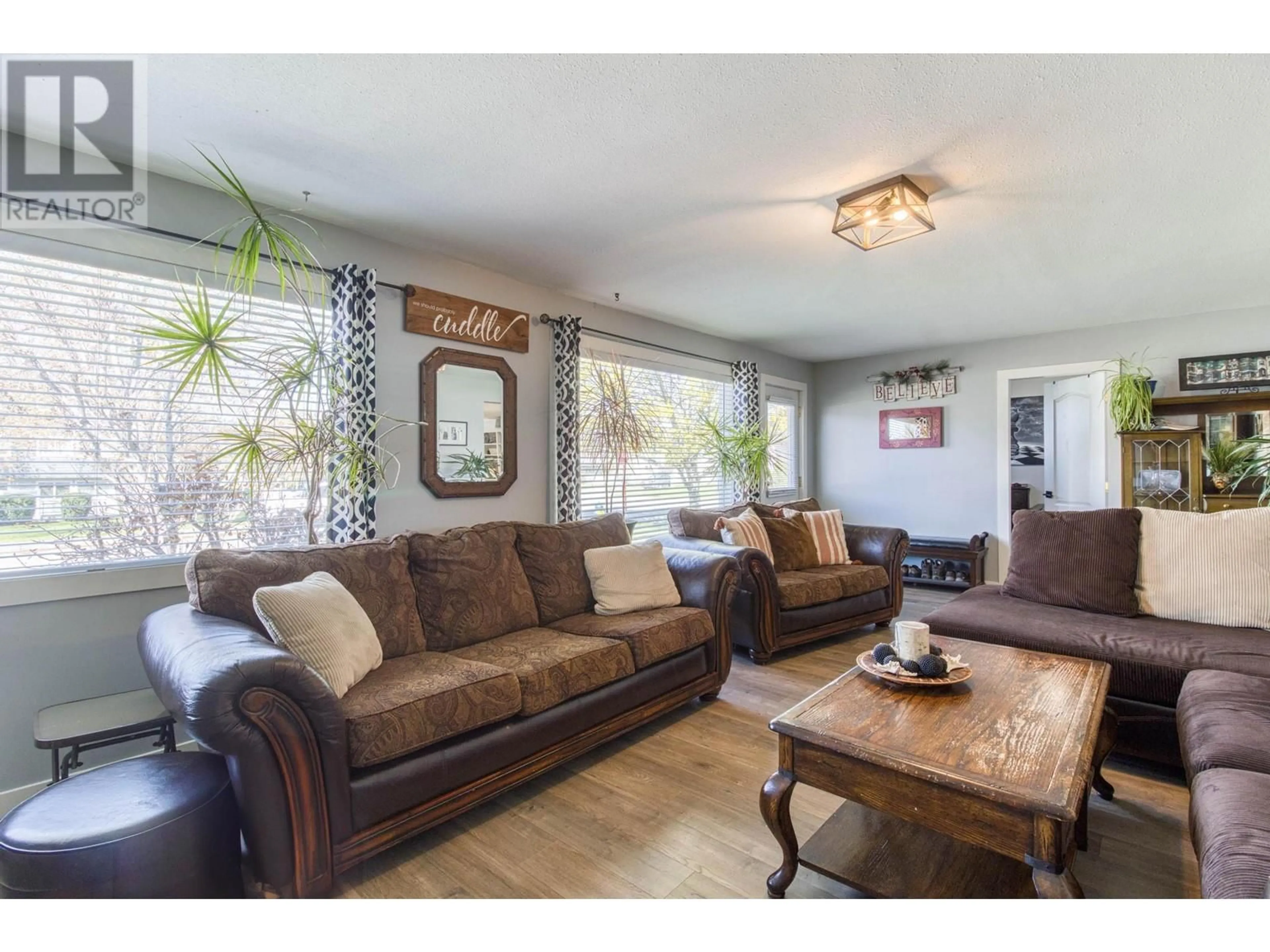 Living room with furniture, wood/laminate floor for 553 ALL STAR COURT, Kelowna British Columbia V1X5N7