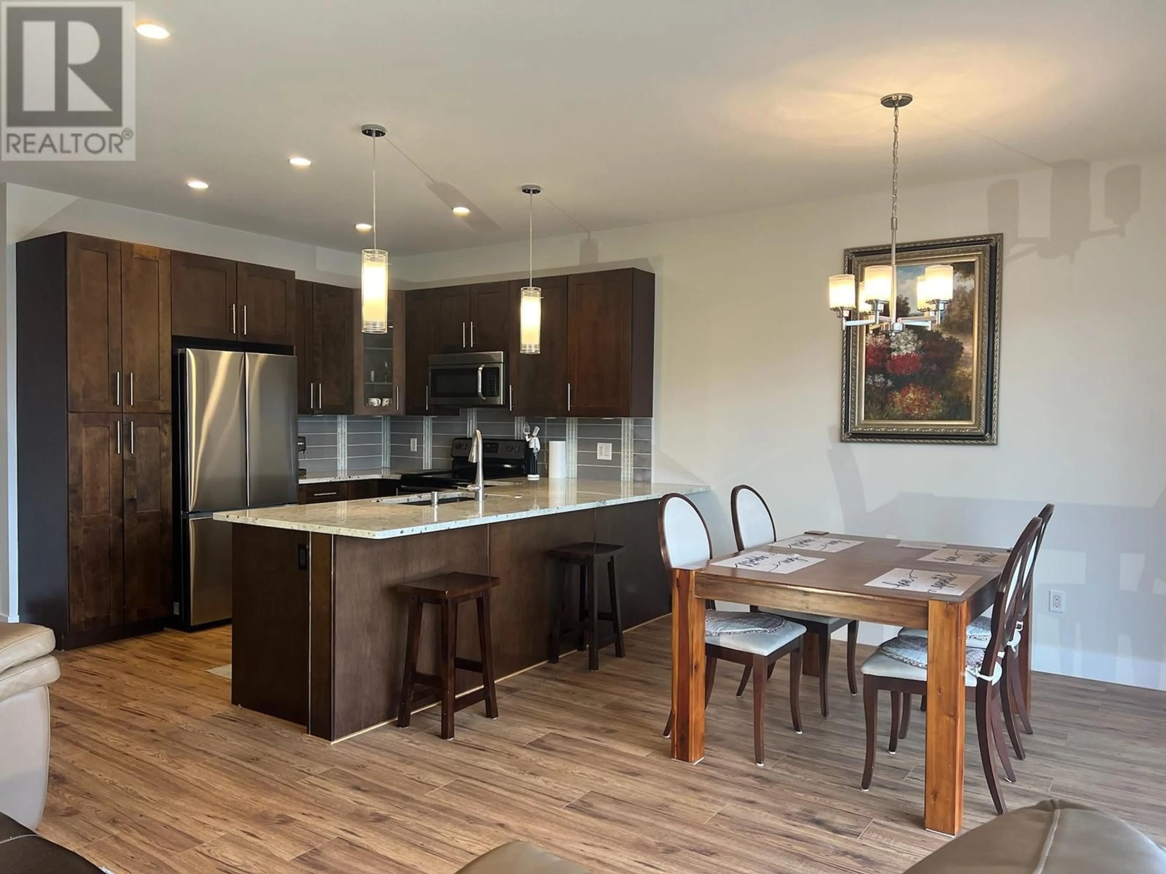 Open concept kitchen, wood/laminate floor for 1274 BERGAMOT AVENUE, Kelowna British Columbia V1W5K5