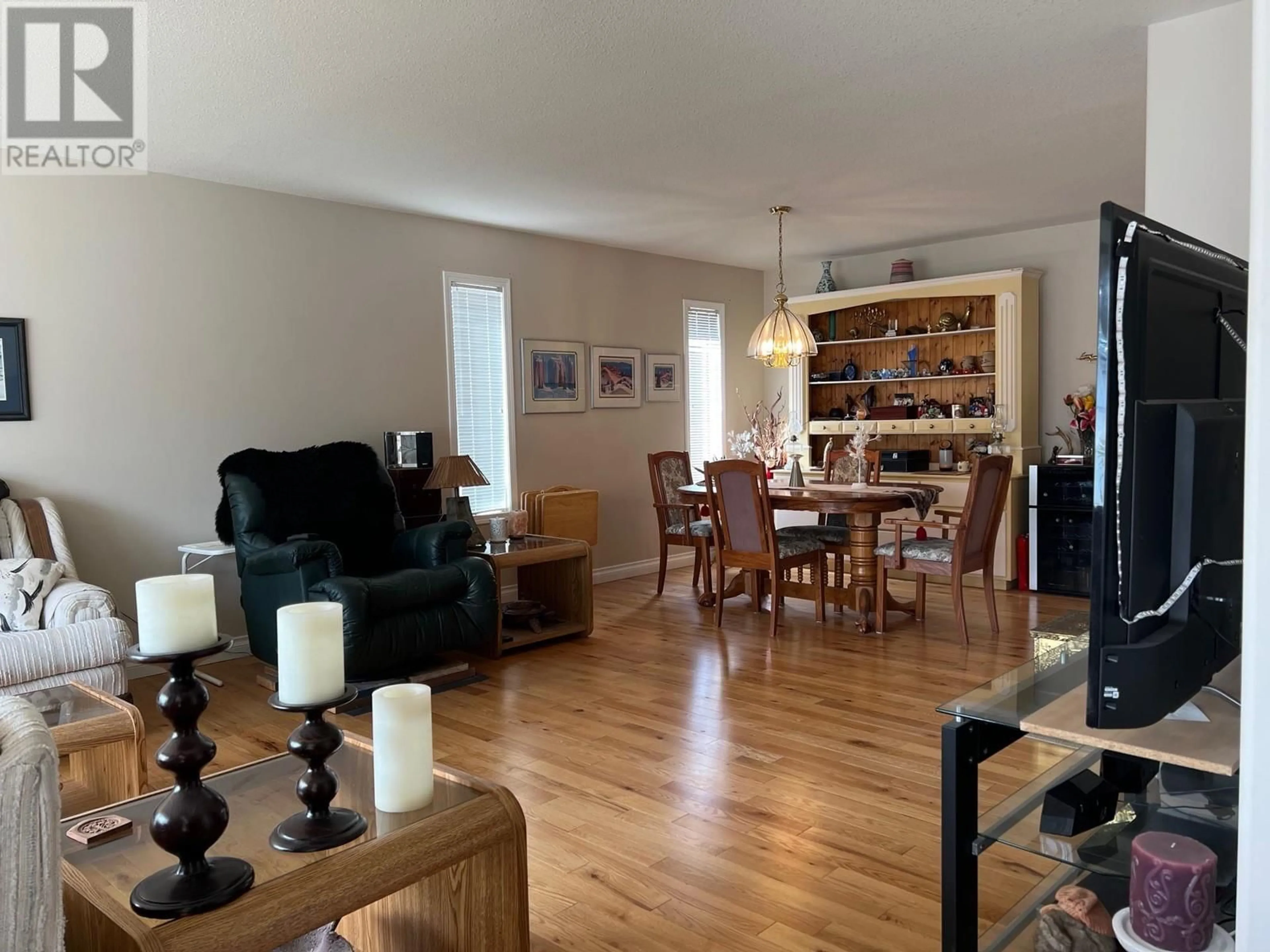 Living room with furniture, wood/laminate floor for 101 1ST STREET, Vernon British Columbia V1H1Z1