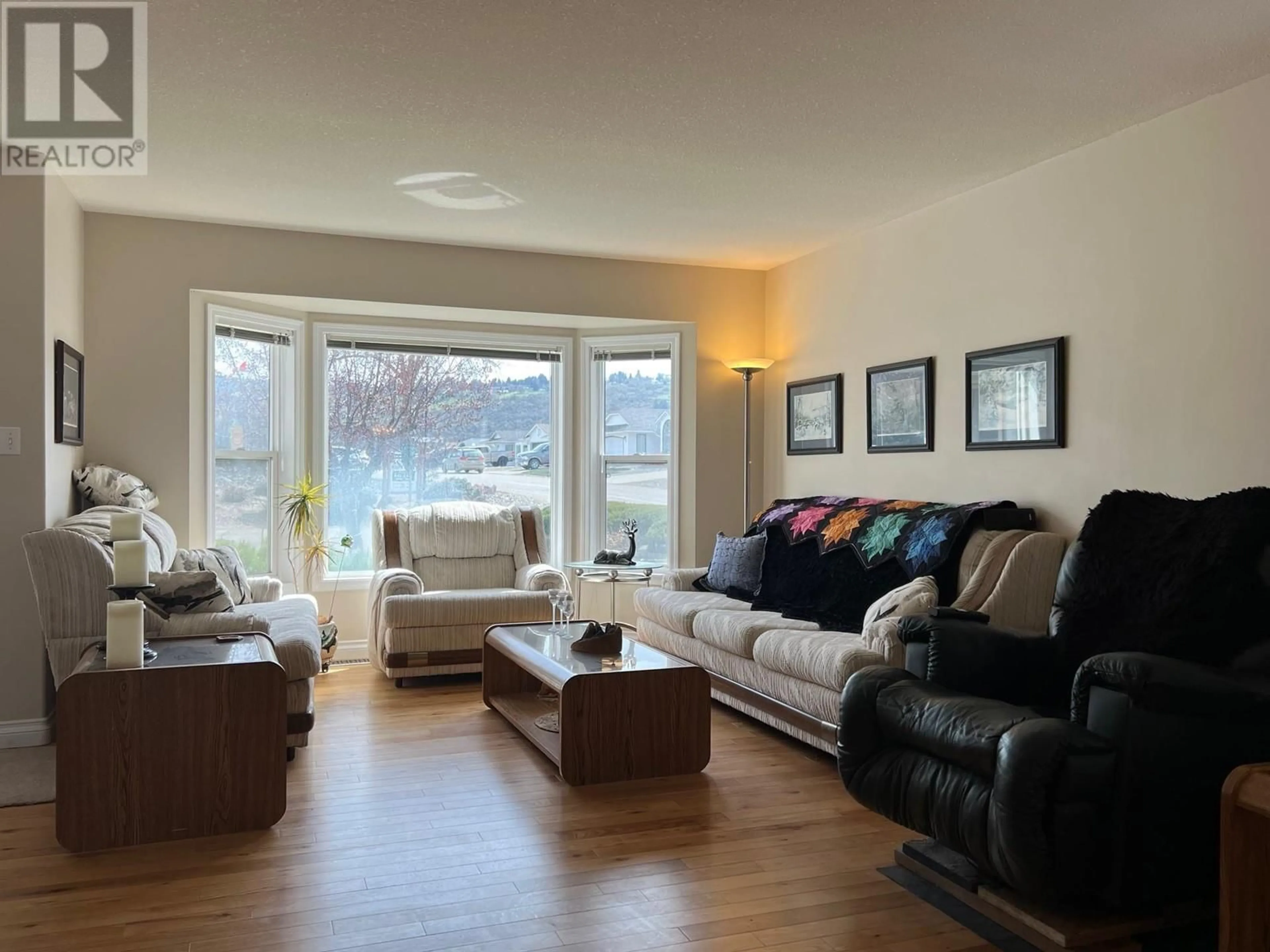 Living room with furniture, wood/laminate floor for 101 1ST STREET, Vernon British Columbia V1H1Z1