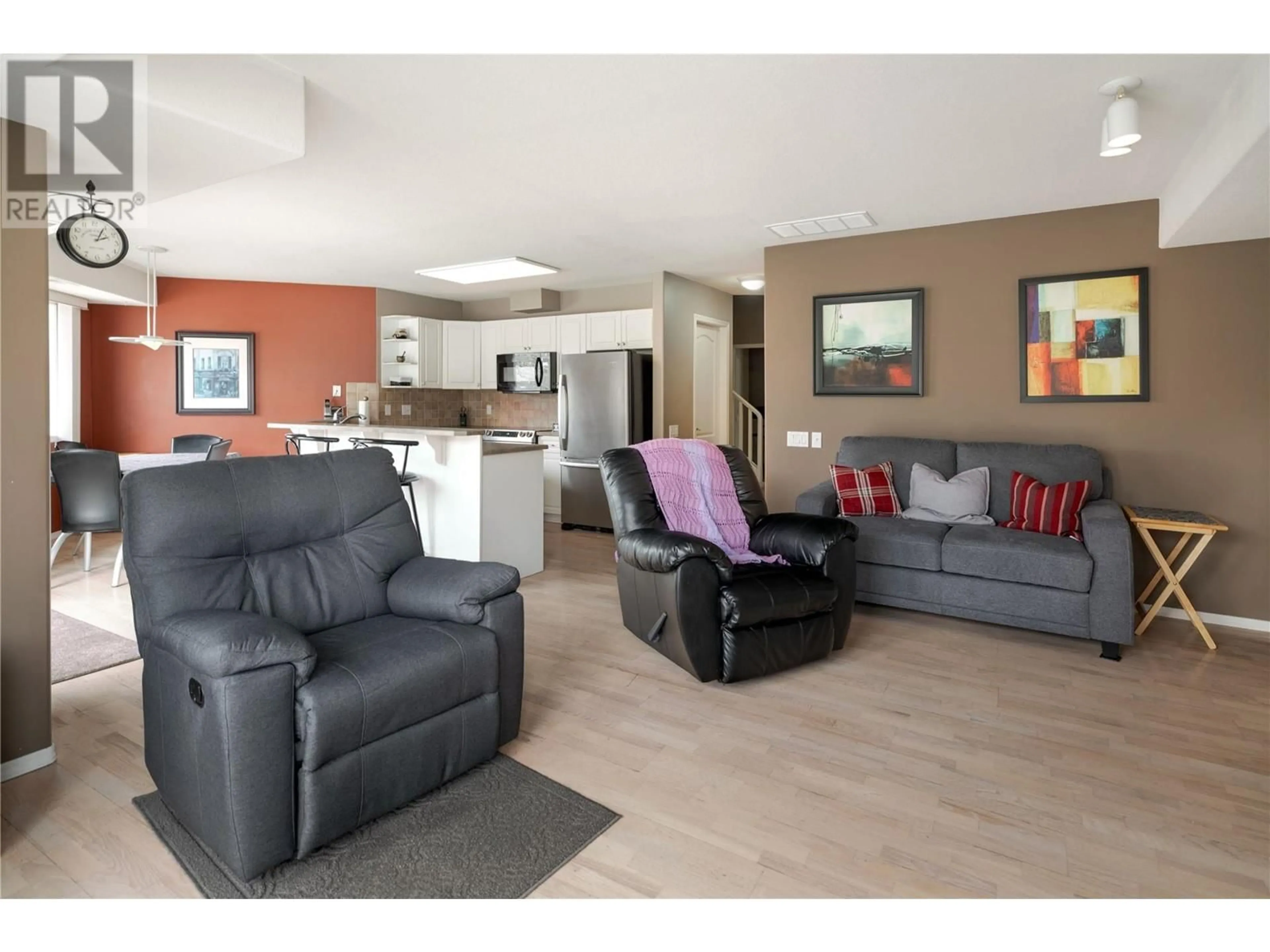 Living room with furniture, wood/laminate floor for 115 - 980 DILWORTH DRIVE, Kelowna British Columbia V1V1S6